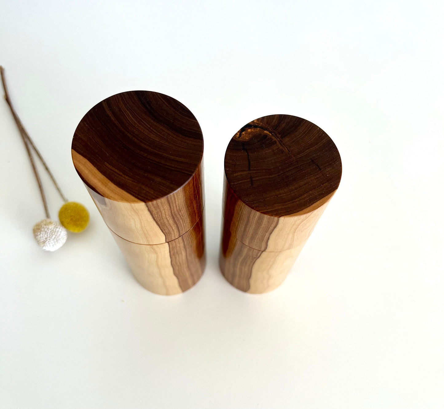 Birdseye view of wooden cylindrical shape salt and pepper grinders made from Australian Buddha timber.