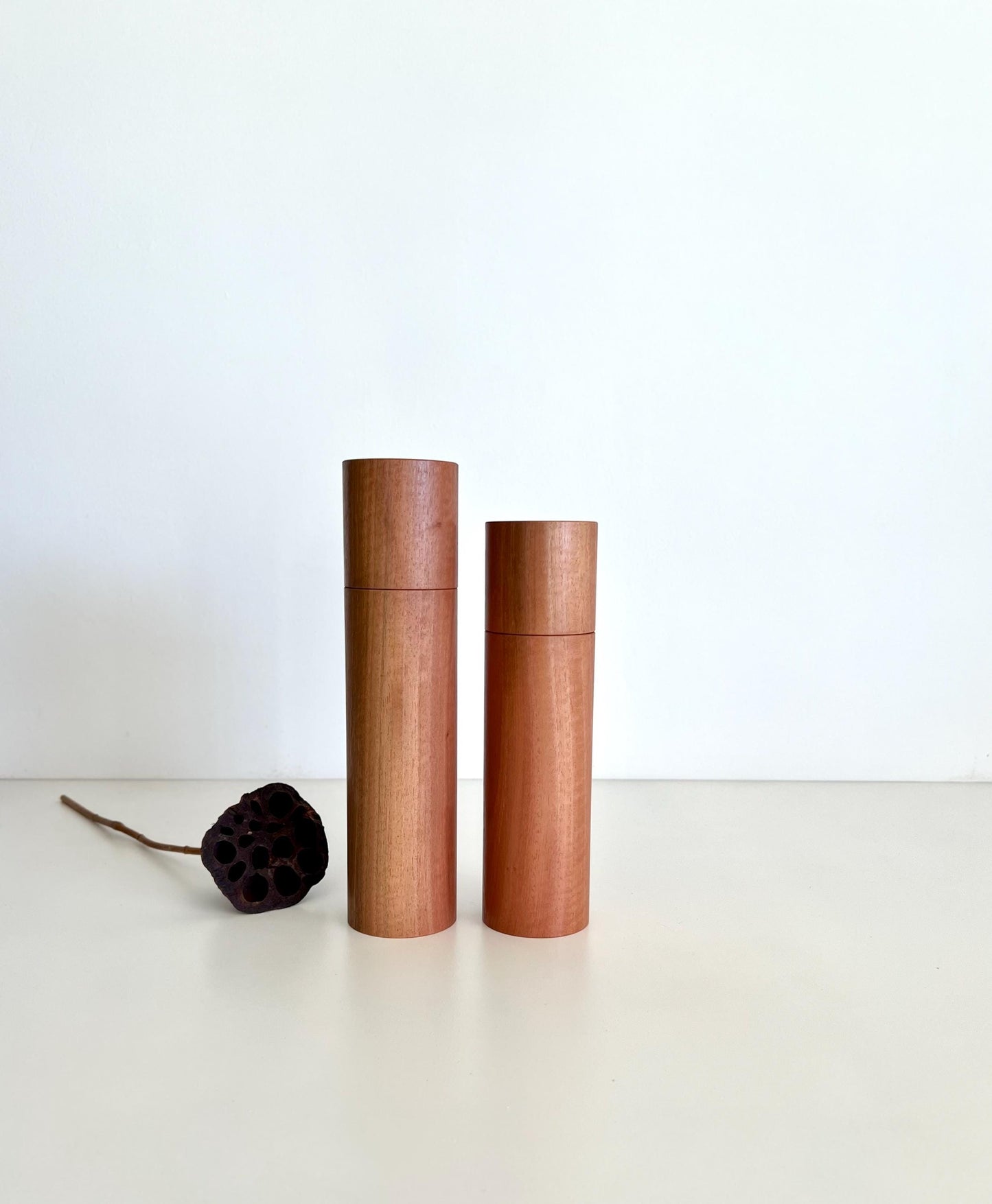 Wooden cylindrical shape salt and pepper grinders made from Australian Southern Mahogany timber.