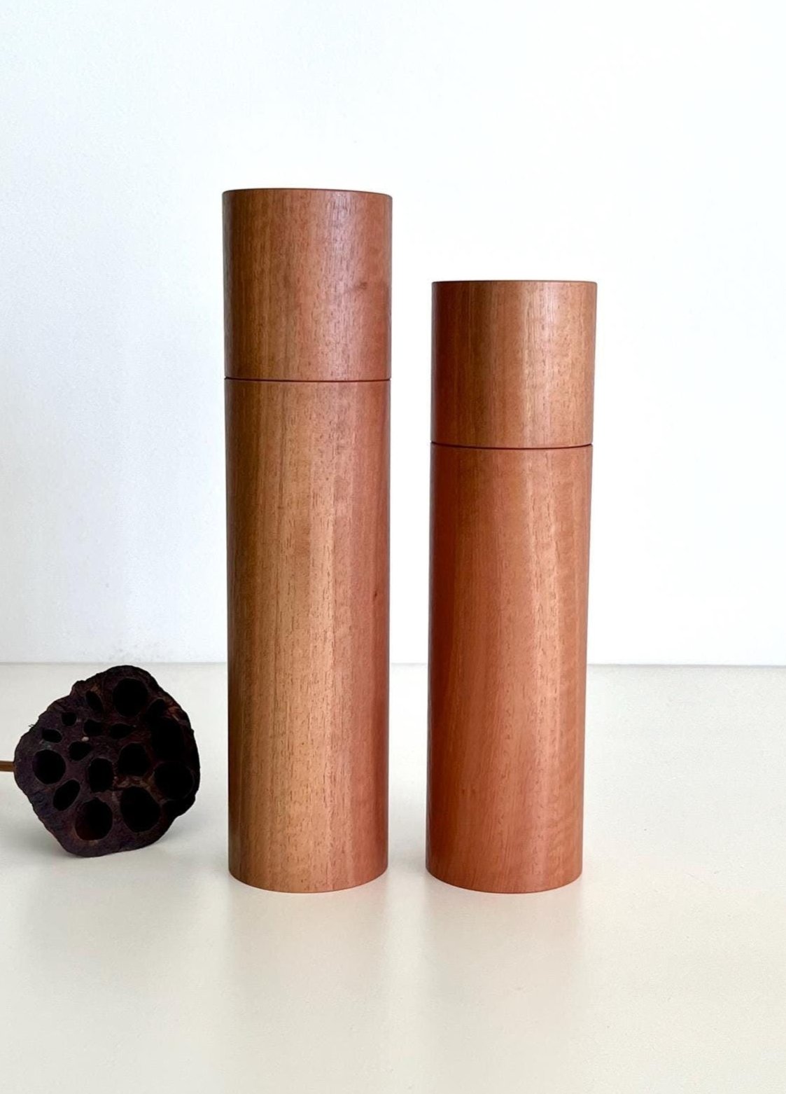 Wooden cylindrical shape salt and pepper grinders made from Australian Southern Mahogany timber.