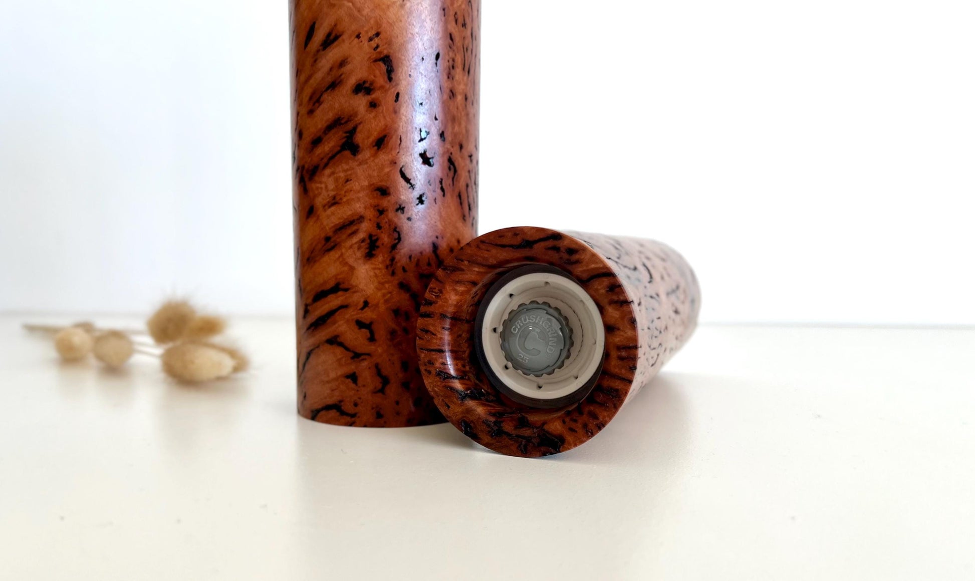 Bottom of salt and pepper grinder showing Crushgrind ceramic grinding mechanism and the adjustment knob