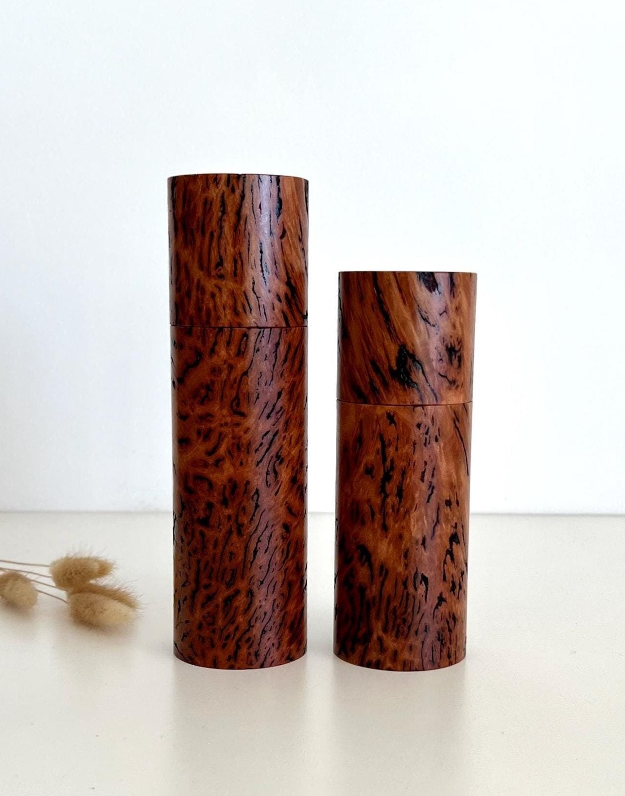 Wooden cylindrical shape salt and pepper grinders made from Australian Wandoo Burl timber.