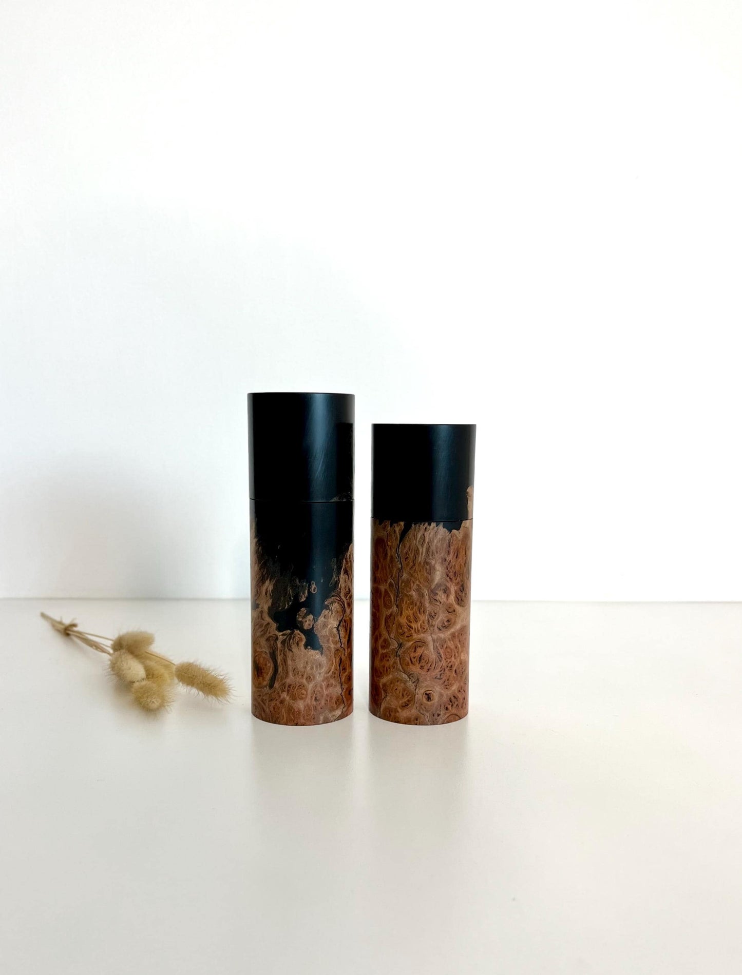 Wooden cylindrical shape salt and pepper grinders made from Australian Jarrah burl timber and Epoxy resin.