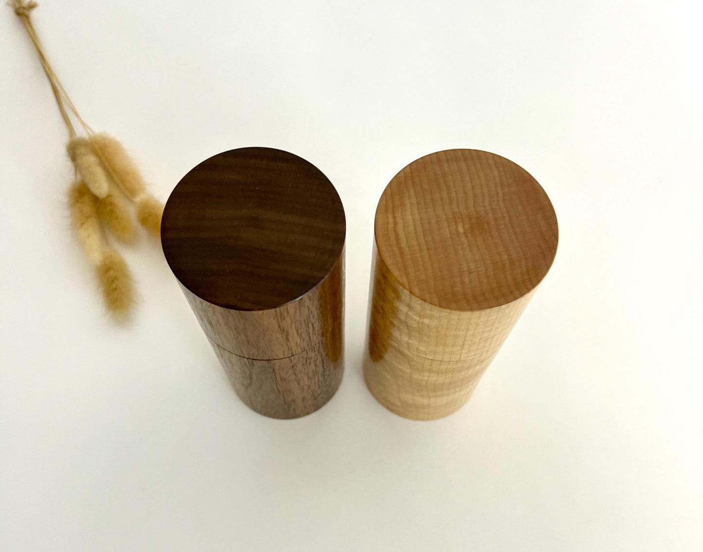 Birdseye view of wooden cylindrical shape salt and pepper grinders made from Black Walnut and Maple timbers