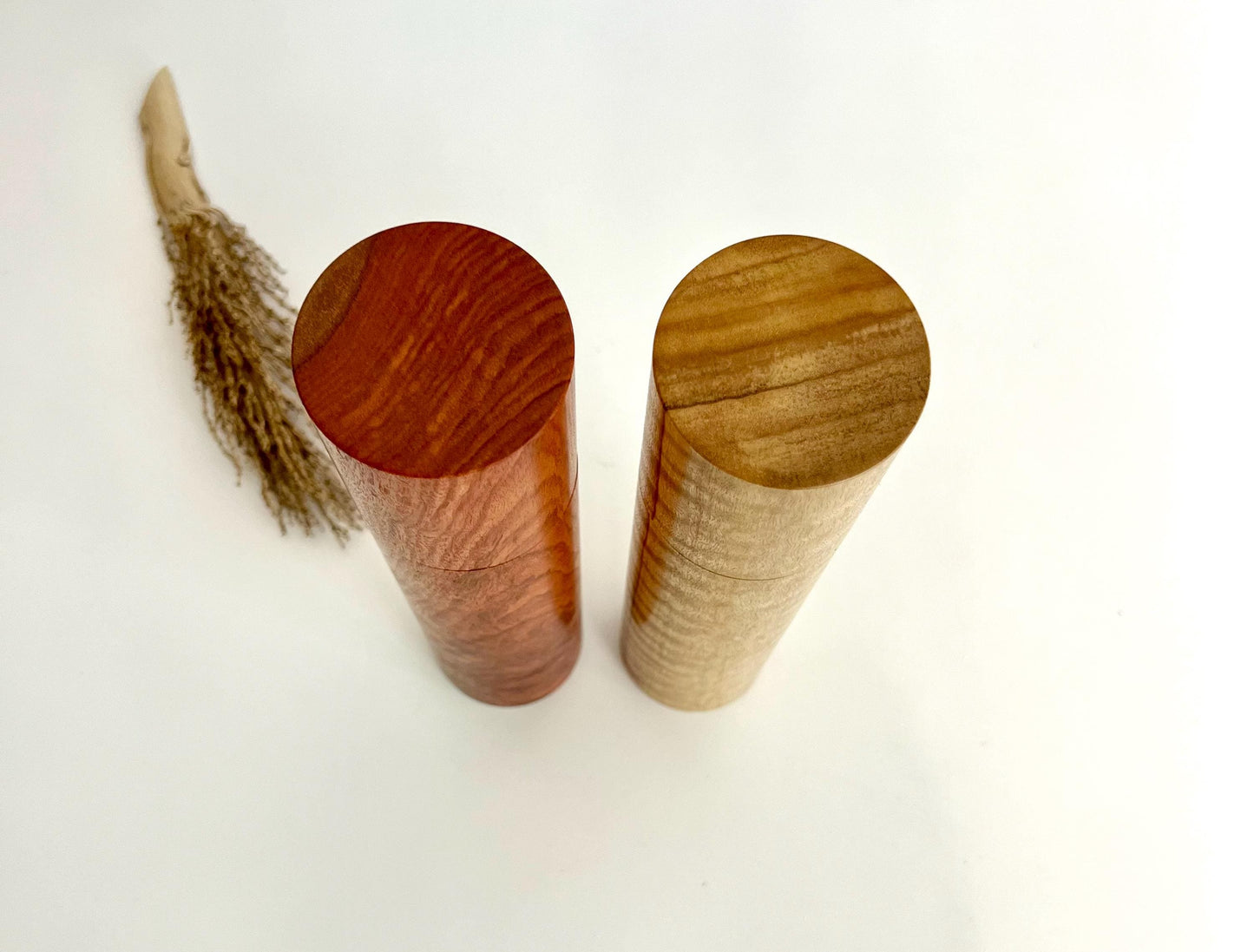 Birdseye view of wooden cylindrical shape salt and pepper grinders made from Australian Jarrah and Narrow leaf peppermint timbers