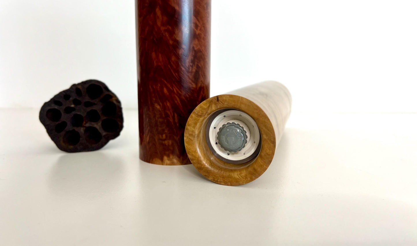 Bottom of salt and pepper grinder showing Crushgrind ceramic grinding mechanism and the adjustment knob