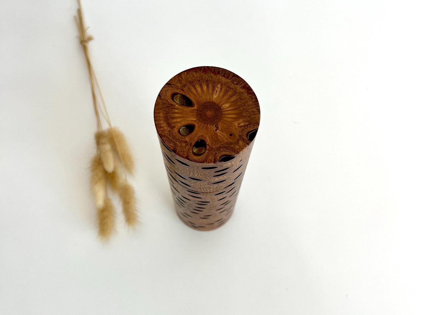 Birdseye view of wooden cylindrical shape salt and pepper grinder made from Australian Banksia Seed Pod