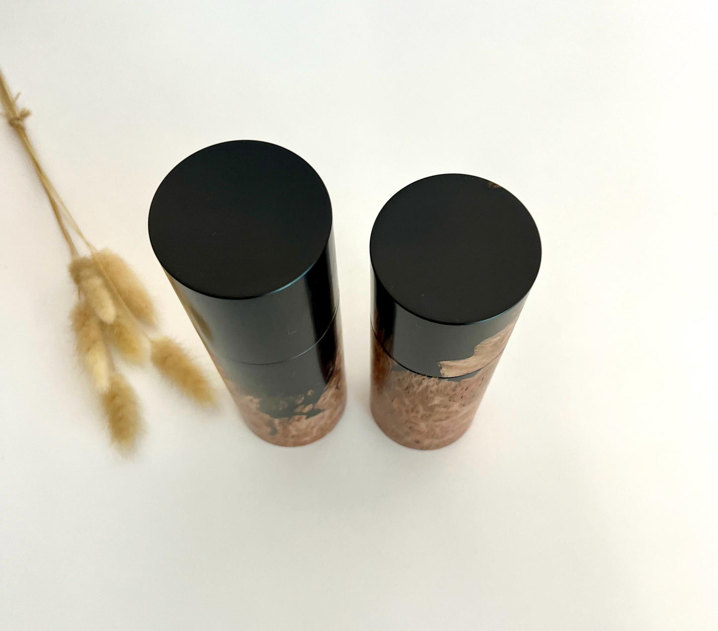 Birdseye view of wooden cylindrical shape salt and pepper grinders made from Australian Jarrah burl timber and Epoxy resin