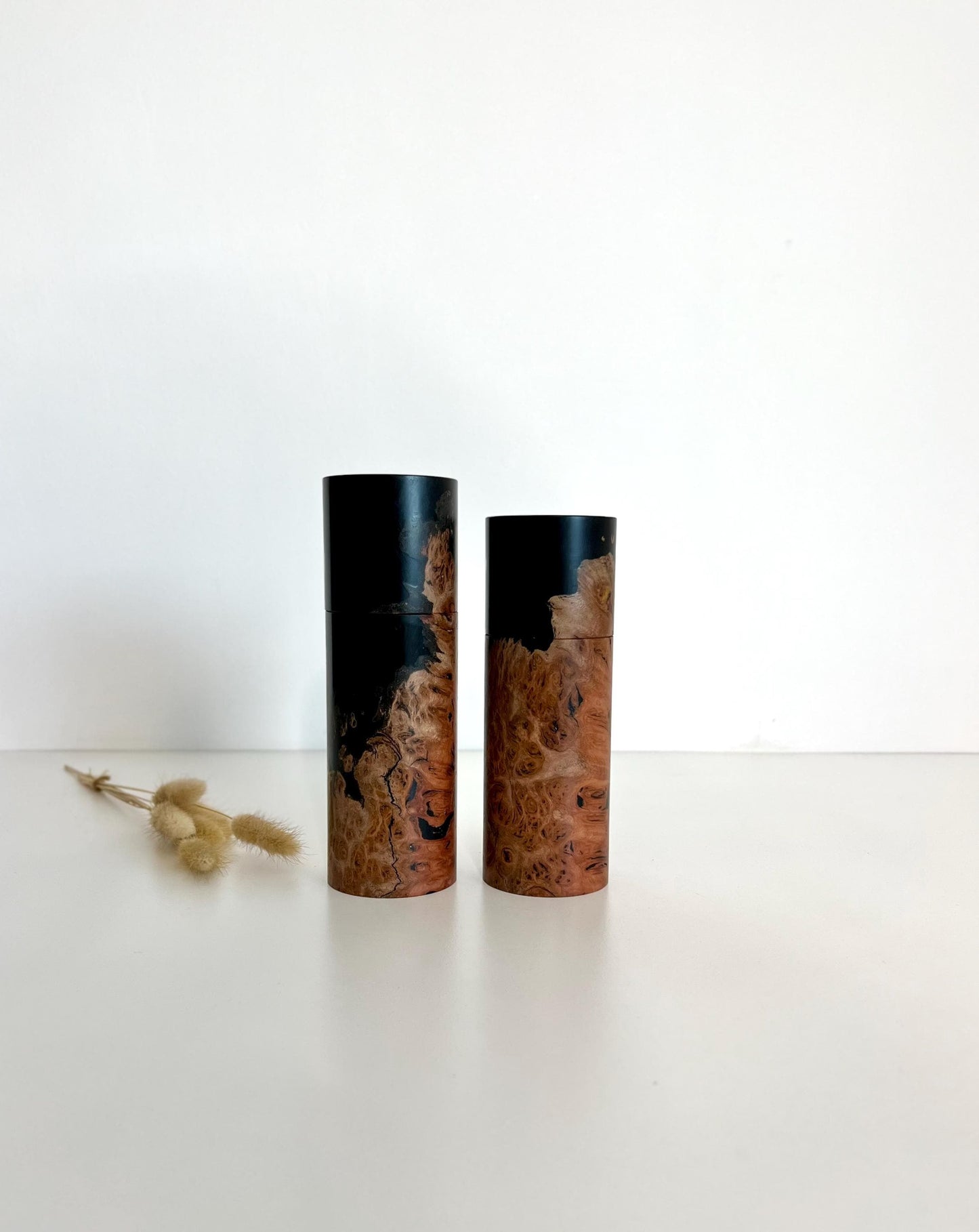 Wooden cylindrical shape salt and pepper grinders made from Australian Jarrah burl timber and Epoxy resin.