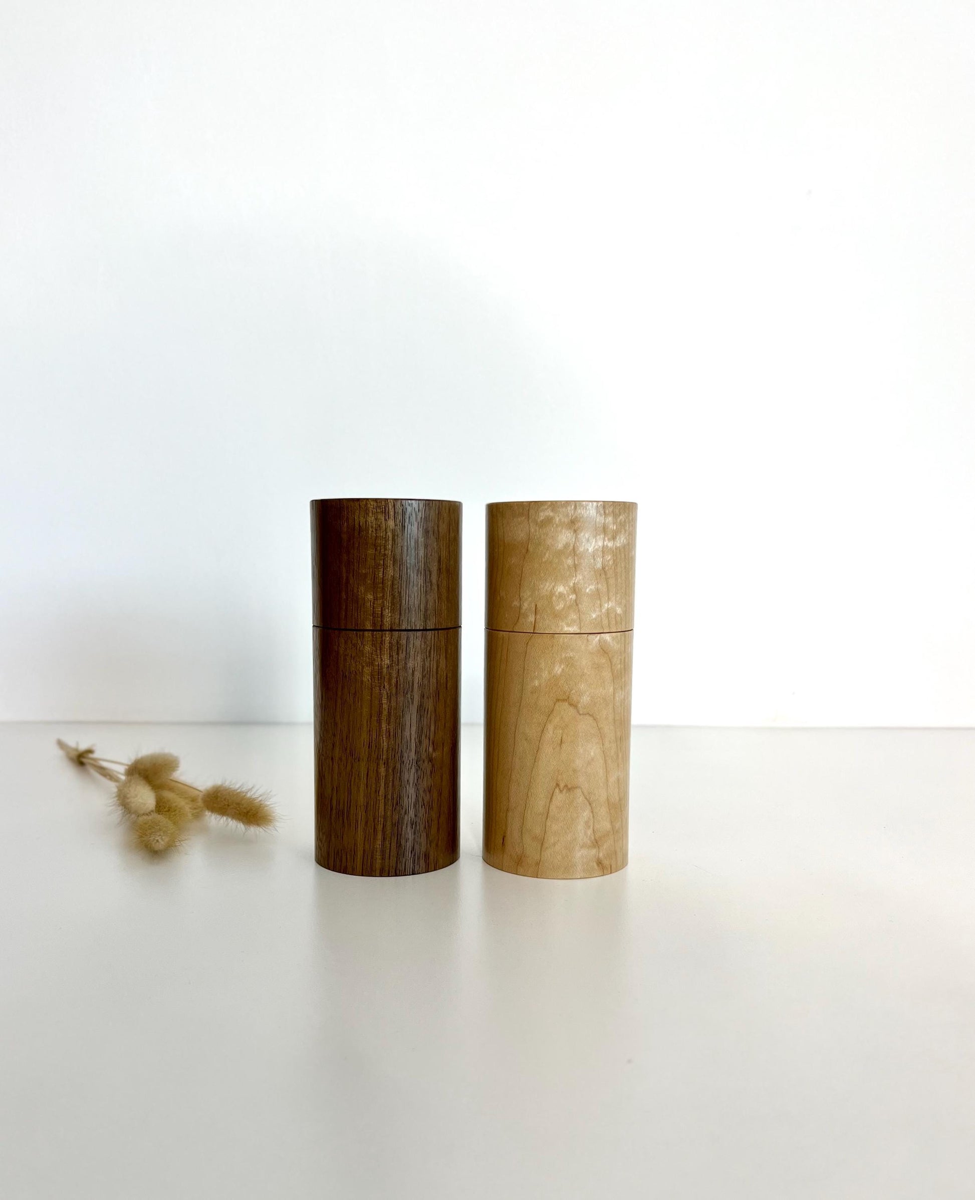 Wooden cylindrical shape salt and pepper grinders made from Maple and Black Walnut timbers