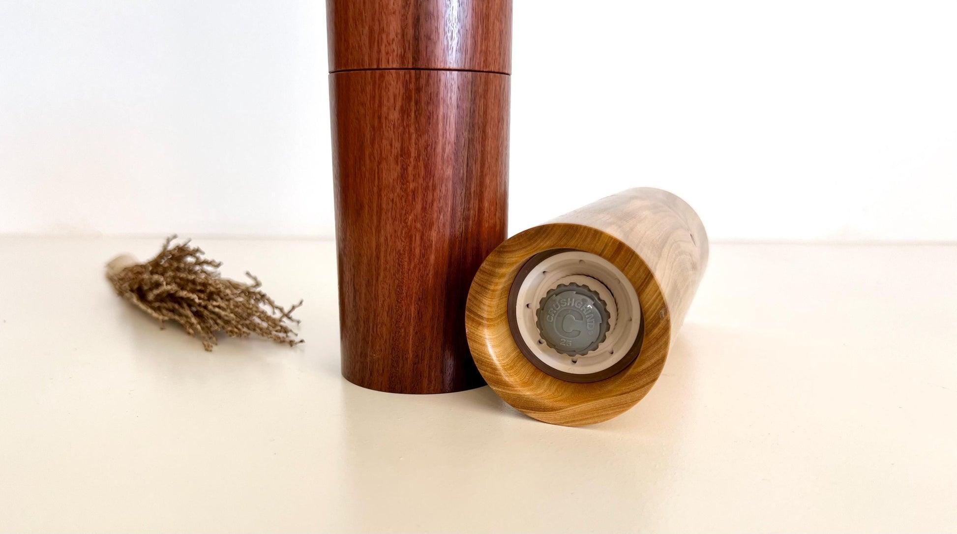 Bottom of salt and pepper grinder showing Crushgrind ceramic grinding mechanism and the adjustment knob