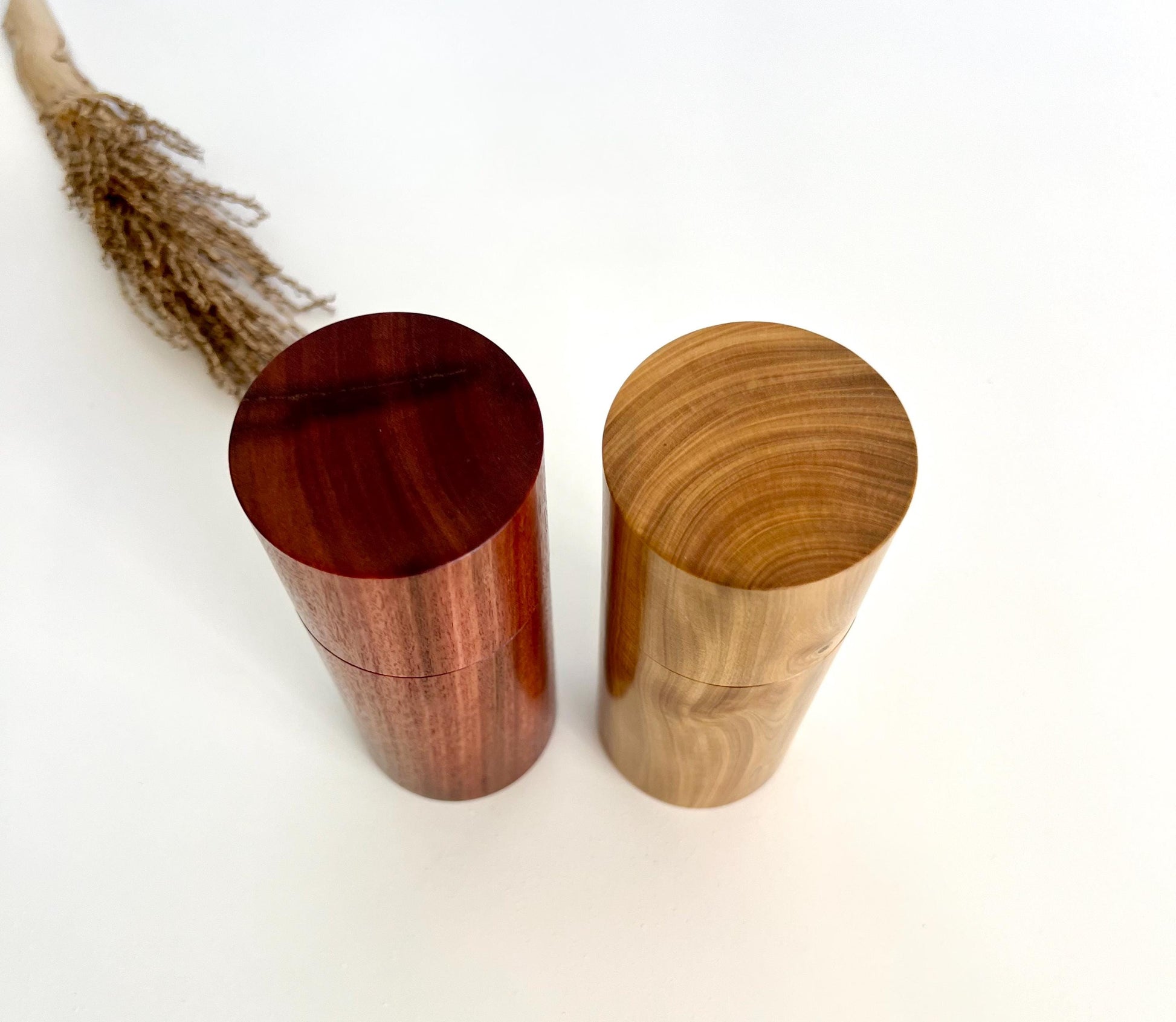 Birdseye view of wooden cylindrical shape salt and pepper grinders made from Slamon gum and Wilga timbers