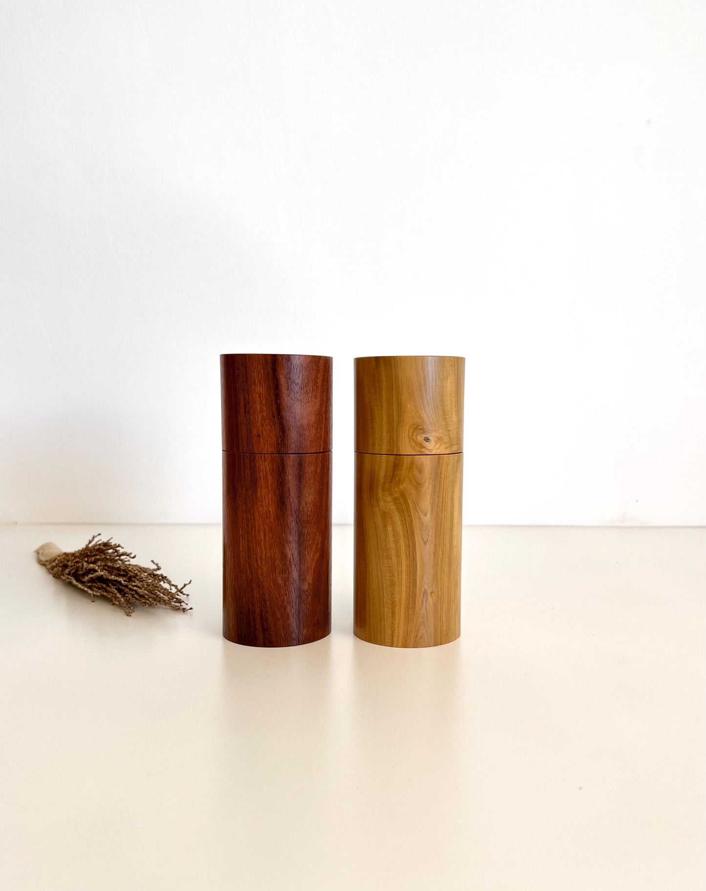 Wooden cylindrical shape salt and pepper grinders made from salmon gum and Wilga timbers