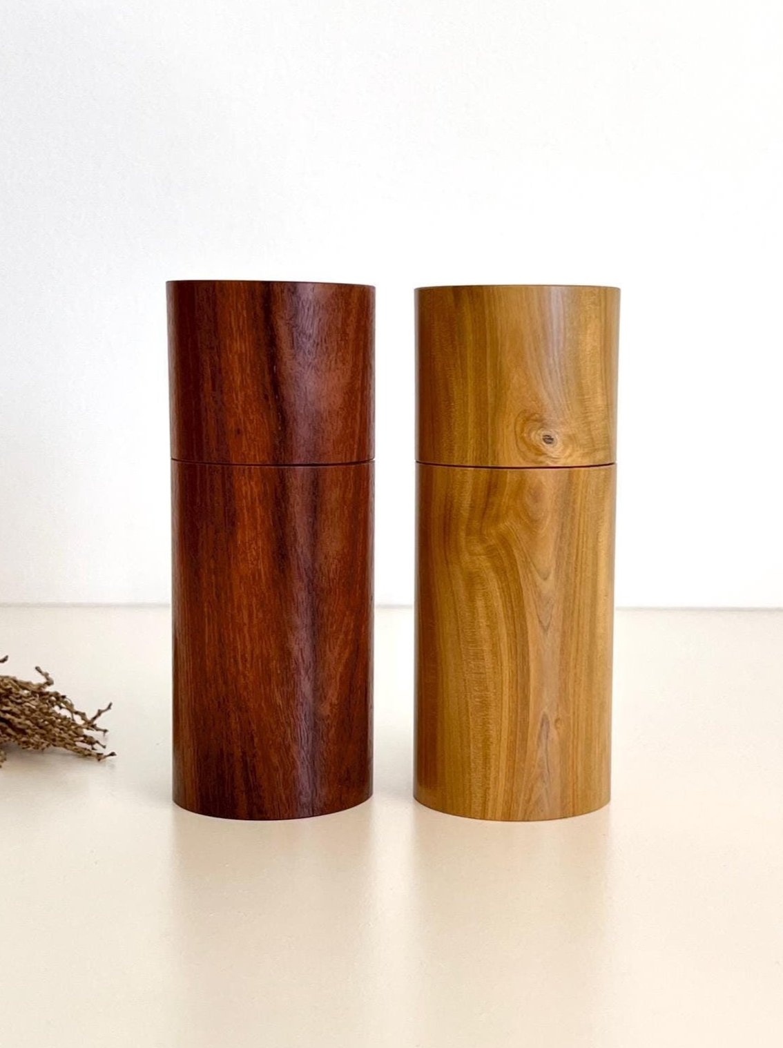 Wooden cylindrical shape salt and pepper grinders made from salmon gum and Wilga timbers