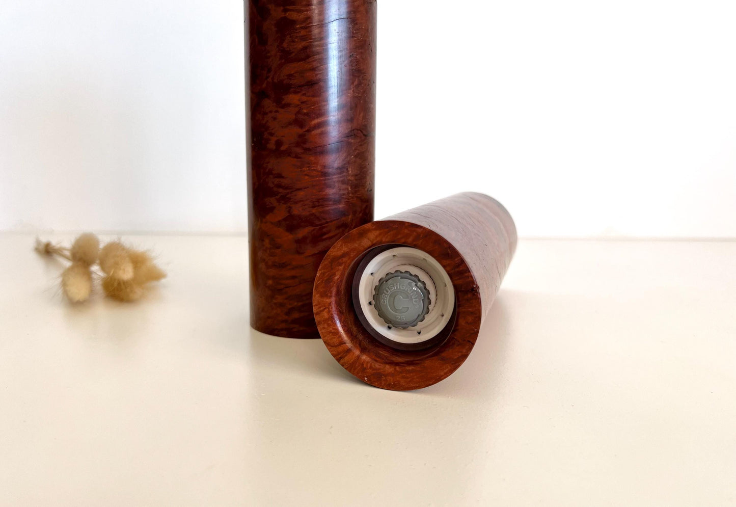 Bottom of salt and pepper grinder showing Crushgrind ceramic grinding mechanism and the adjustment knob