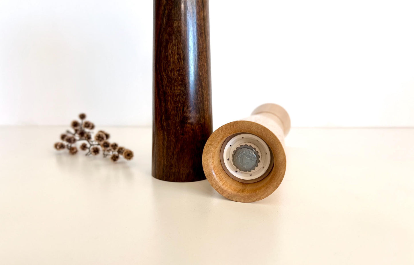 Bottom of salt and pepper grinder showing Crushgrind ceramic grinding mechanism and the adjustment knob