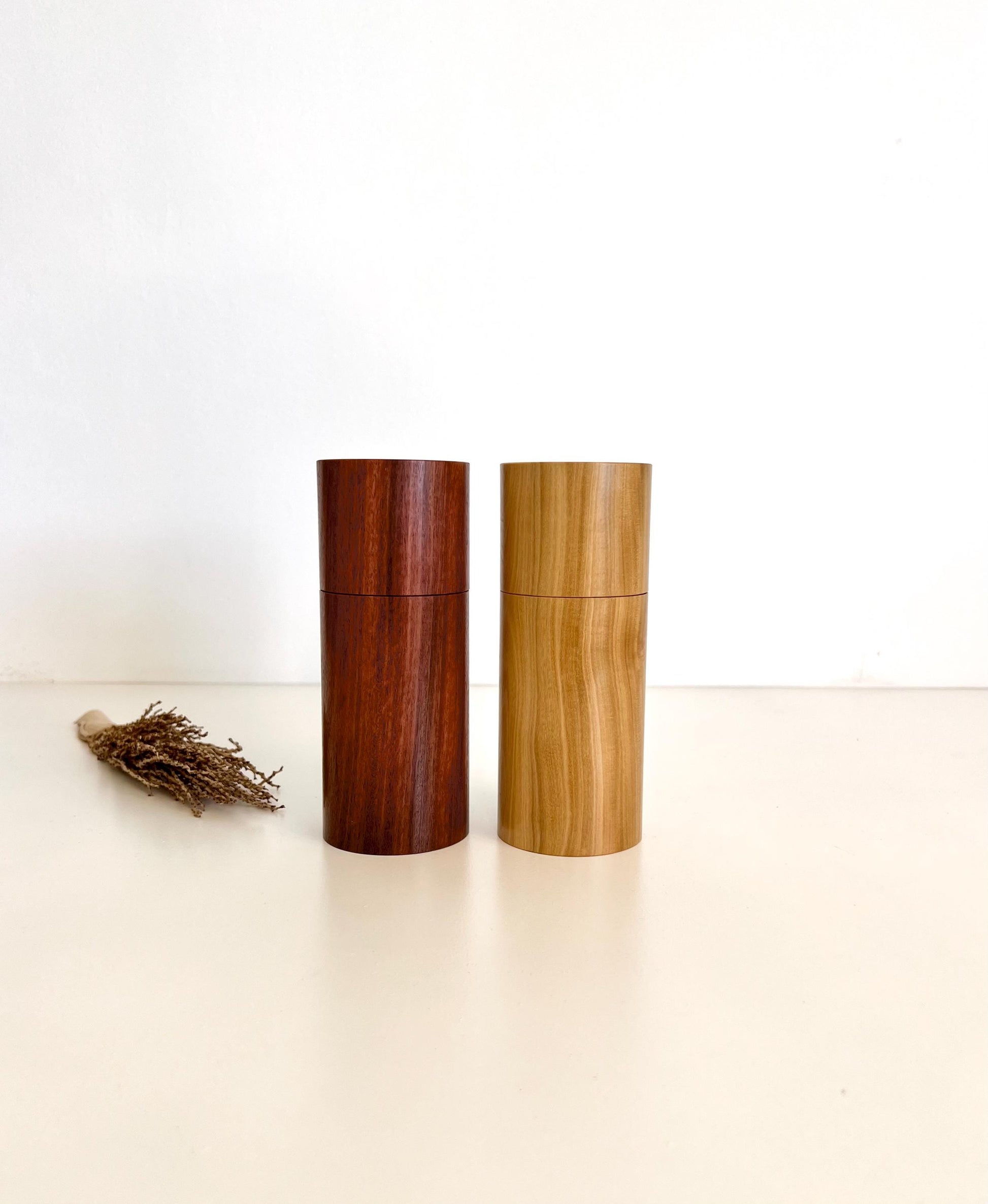 Wooden cylindrical shape salt and pepper grinders made from salmon gum and Wilga timbers