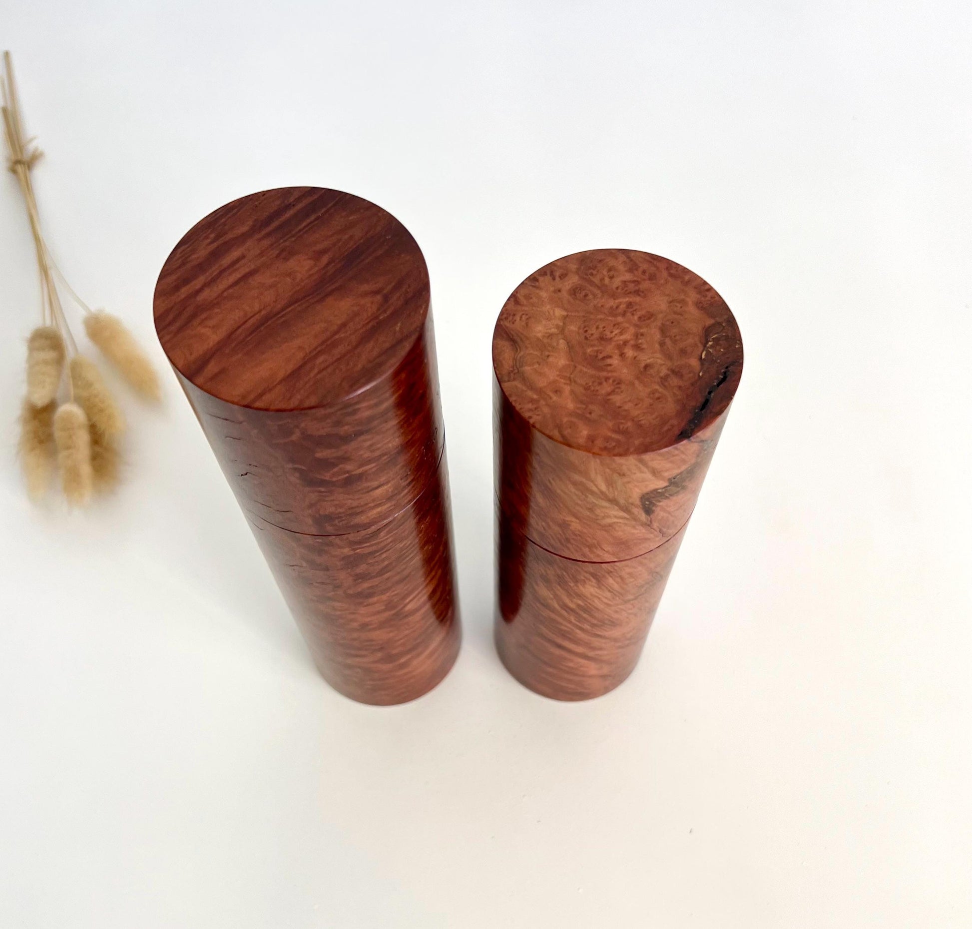 Birdseye view of wooden cylindrical shape salt and pepper grinders made from Australian Red Mallee Burl timber