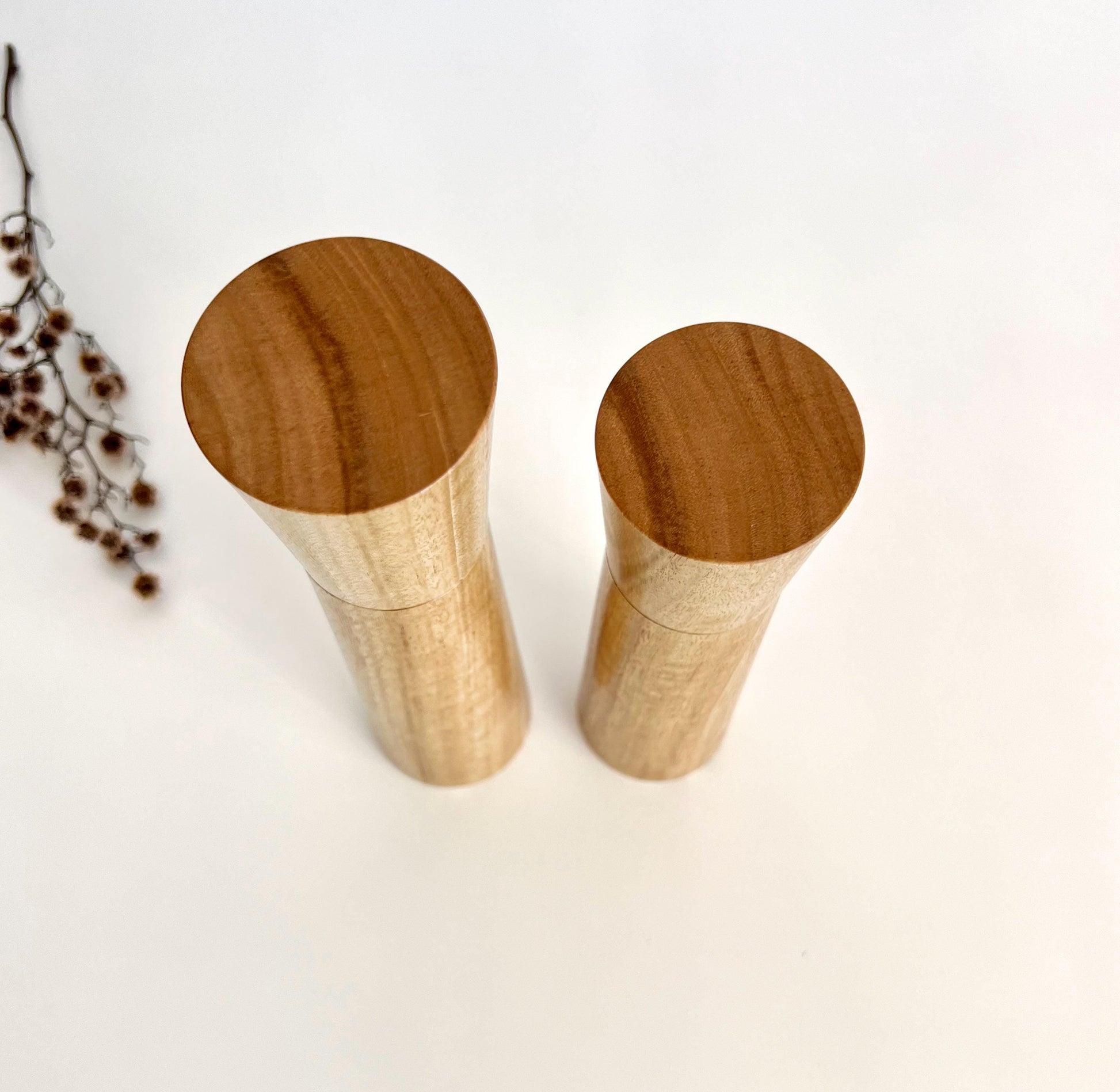 Birdseye view of wooden cylindrical shape salt and pepper grinders made from Australian Blue gum timber