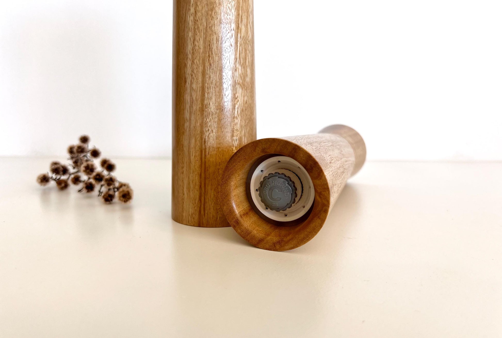 Bottom of salt and pepper grinder showing Crushgrind ceramic grinding mechanism and the adjustment knob