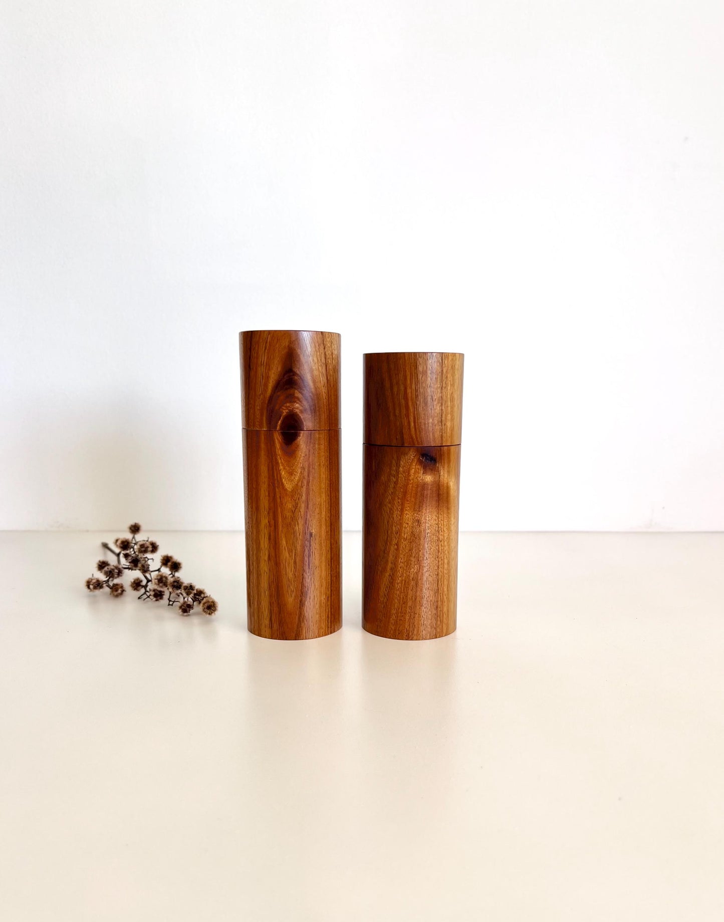 Wooden cylindrical shape salt and pepper grinders made from Black Wattle timber