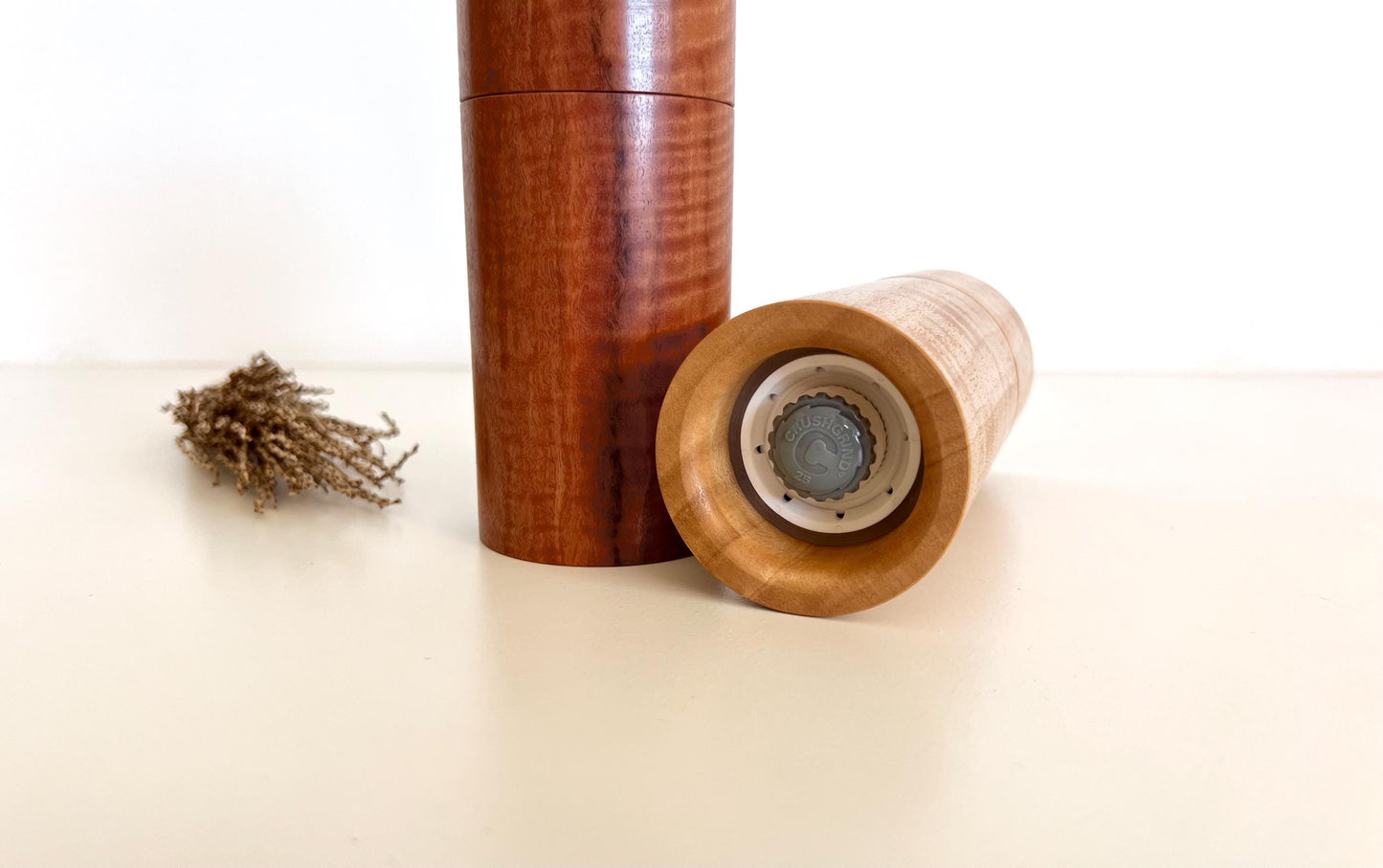 Bottom of salt and pepper grinder showing Crushgrind ceramic grinding mechanism and the adjustment knob