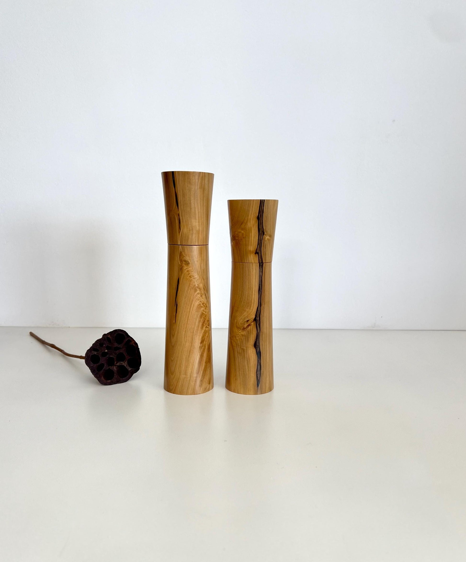 Wooden cylindrical tapered shape salt and pepper grinders made from Australian Wilga timber.