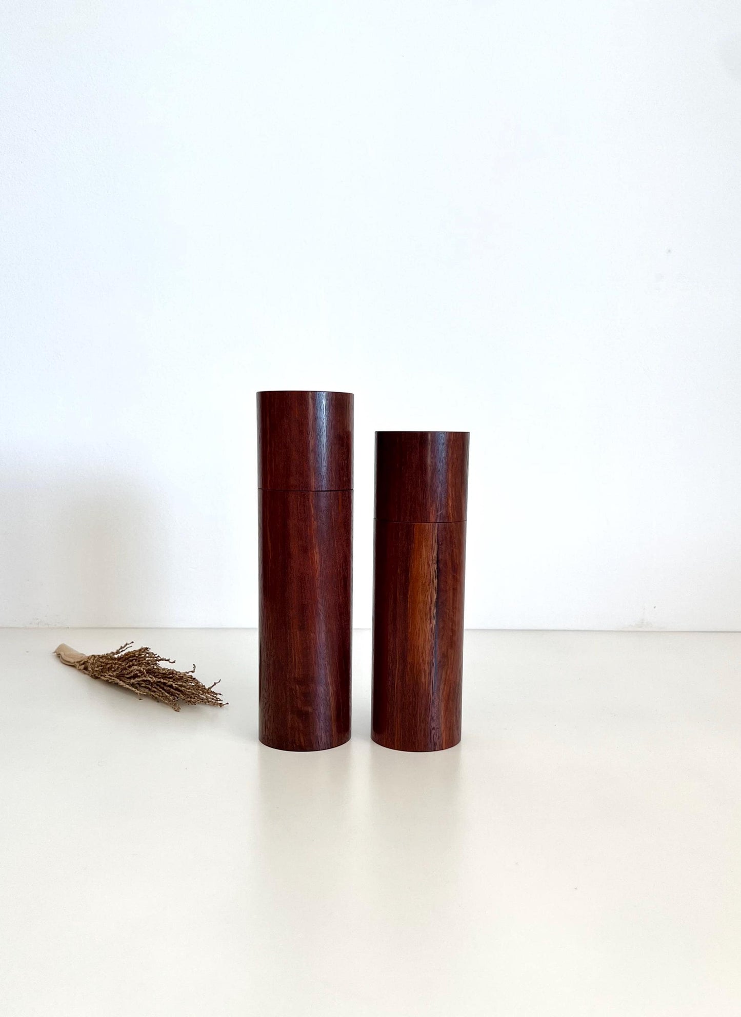 Wooden cylindrical shape salt and pepper grinders made from Australian Jarrah timber.