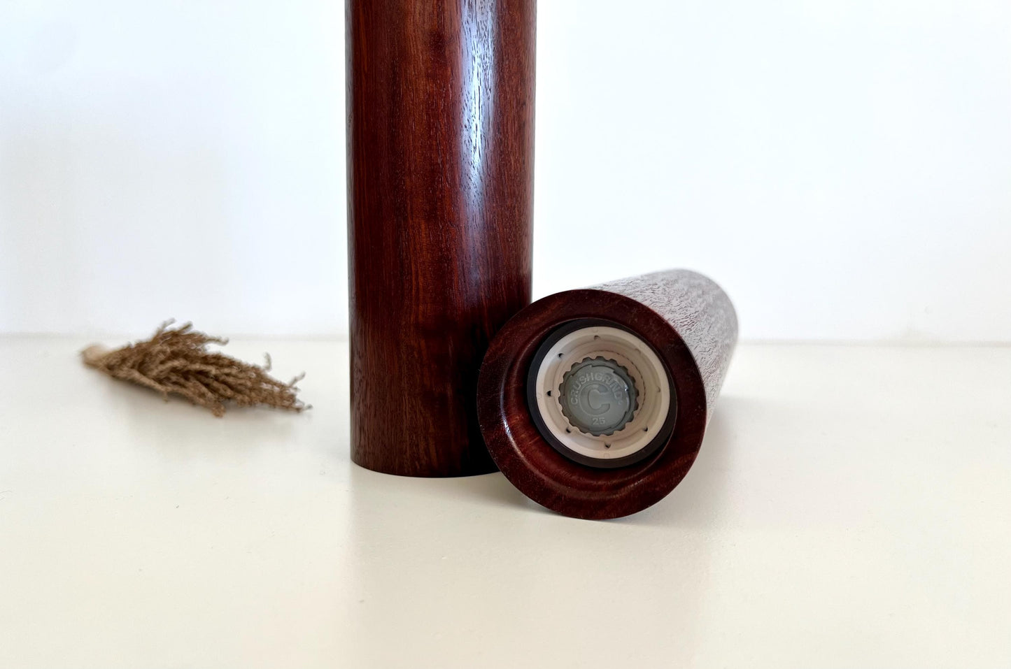 Bottom of salt and pepper grinder showing Crushgrind ceramic grinding mechanism and the adjustment knob