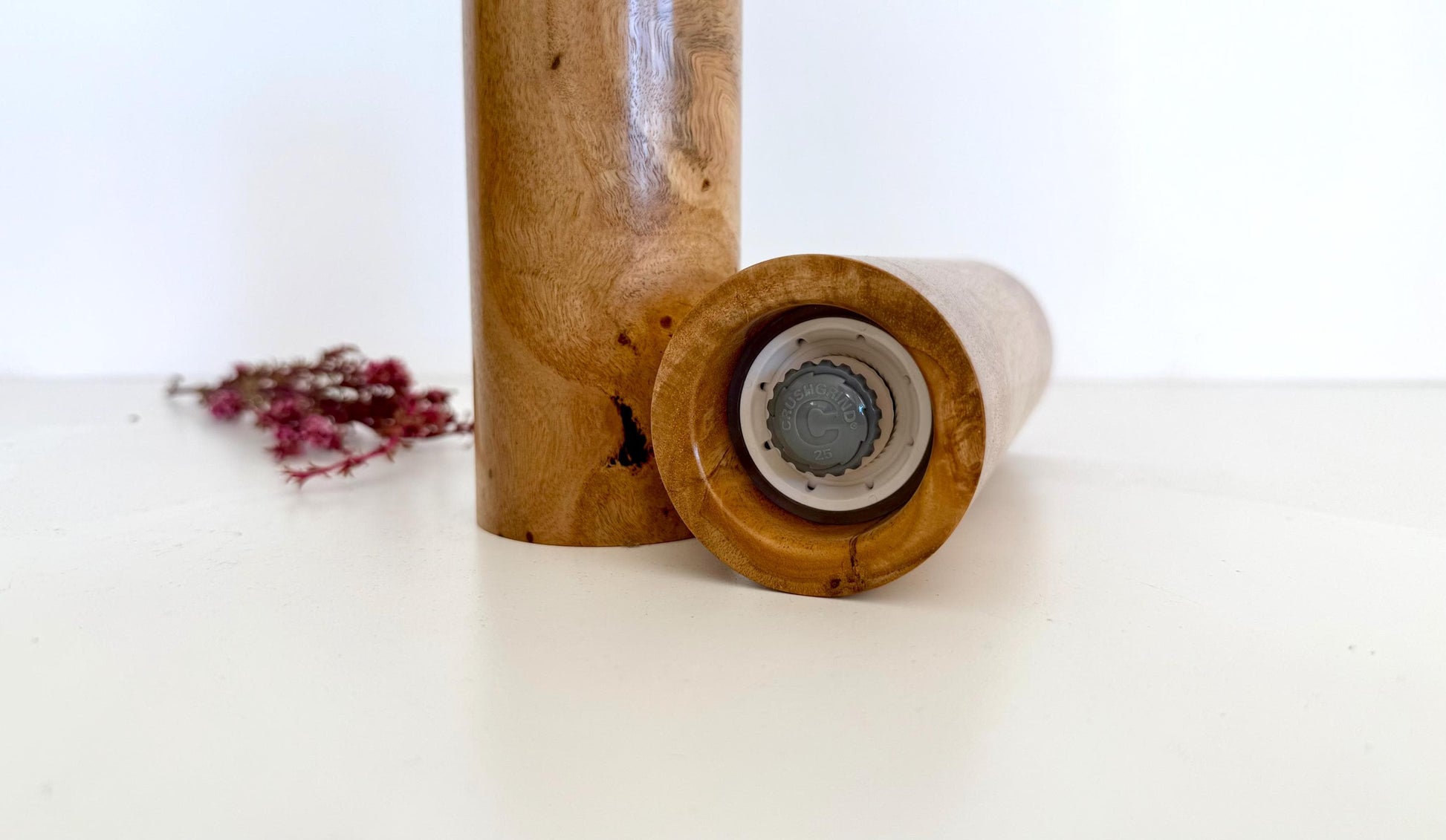 Bottom of salt and pepper grinder showing Crushgrind ceramic grinding mechanism and the adjustment knob