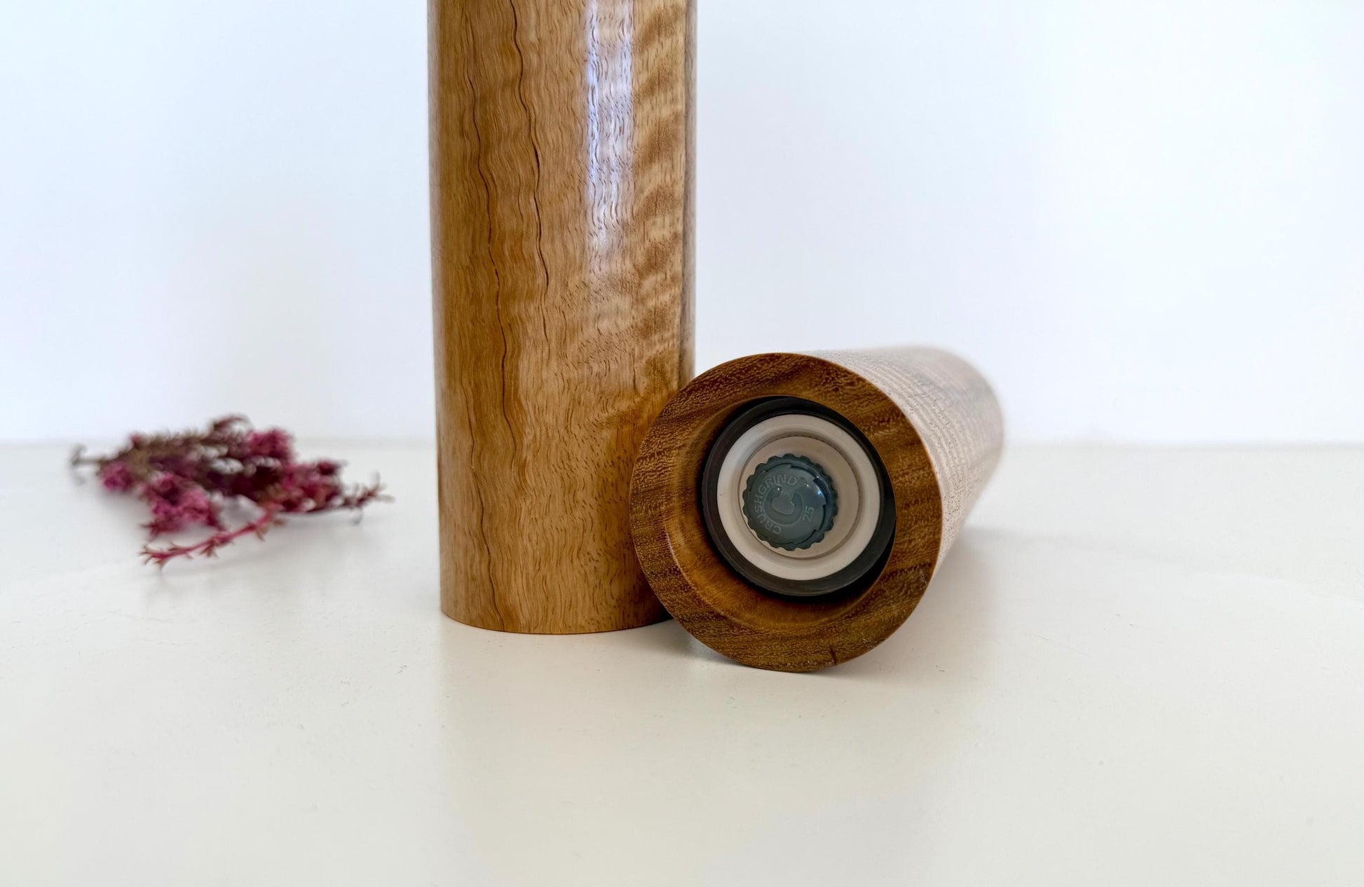 Bottom of salt and pepper grinder showing Crushgrind ceramic grinding mechanism and the adjustment knob