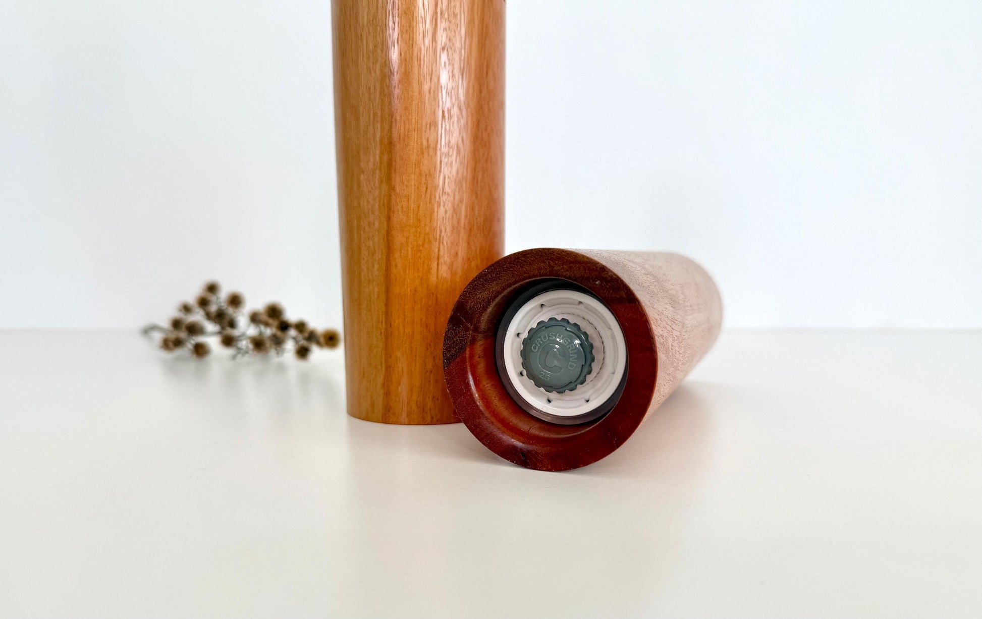 Bottom of salt and pepper grinder showing Crushgrind ceramic grinding mechanism and the adjustment knob