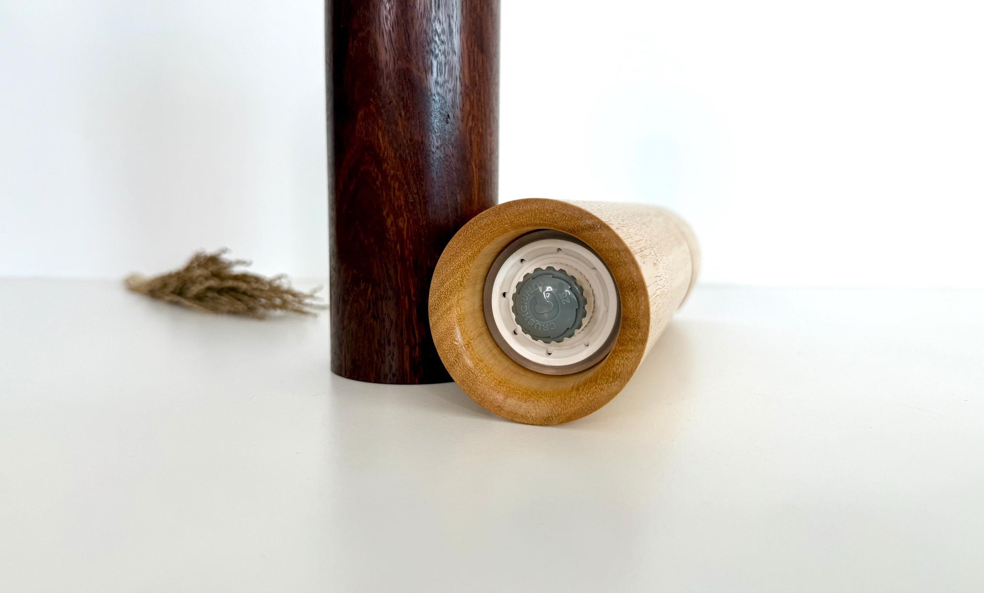 Bottom of salt and pepper grinder showing Crushgrind ceramic grinding mechanism and the adjustment knob