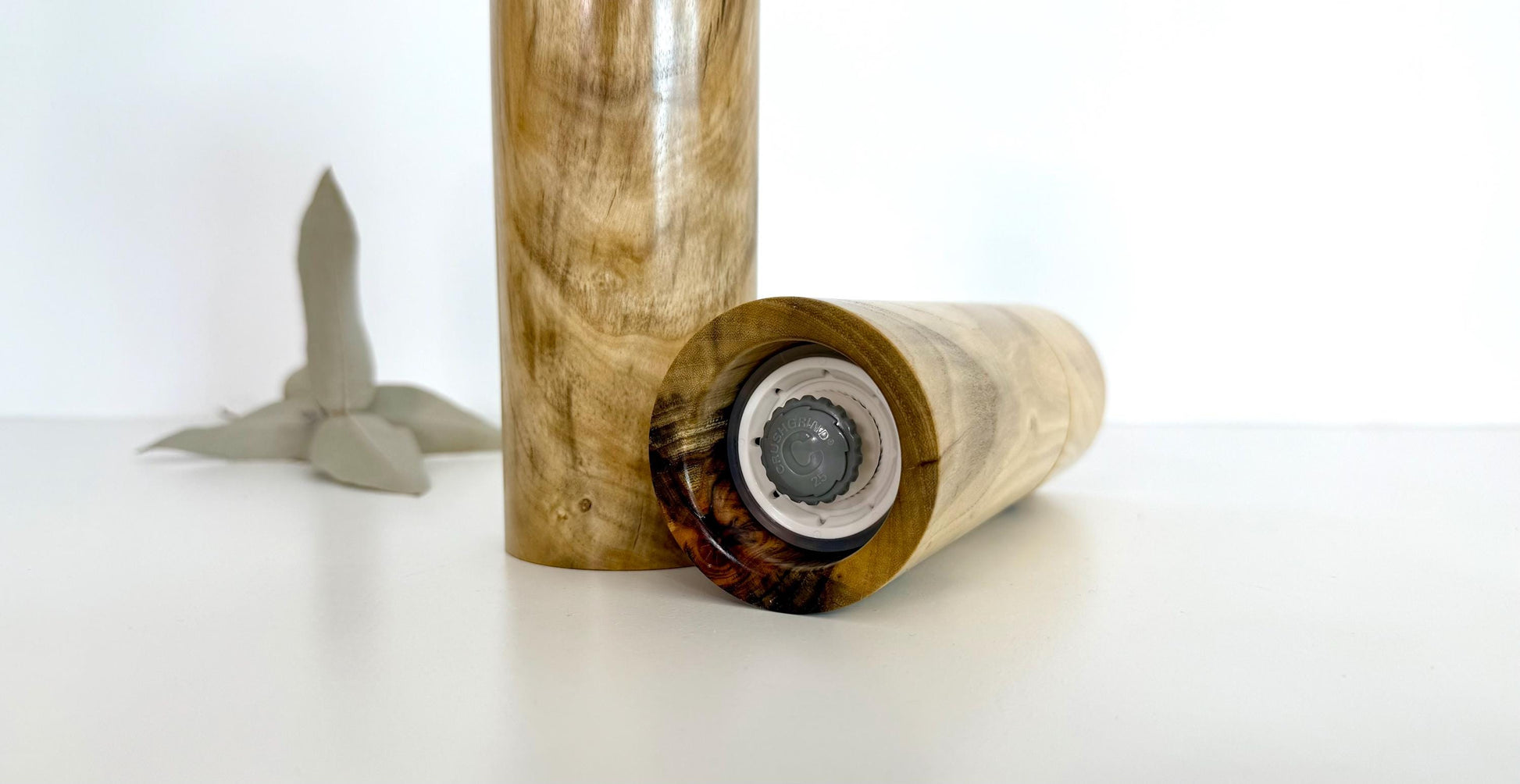 Bottom of salt and pepper grinder showing Crushgrind ceramic grinding mechanism and the adjustment knob