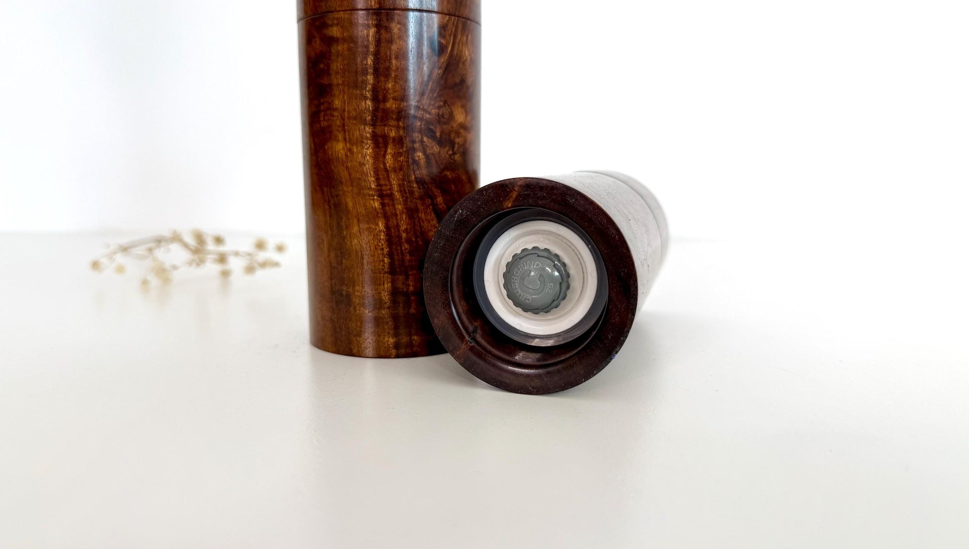 Bottom of salt and pepper grinder showing Crushgrind ceramic grinding mechanism and the adjustment knob