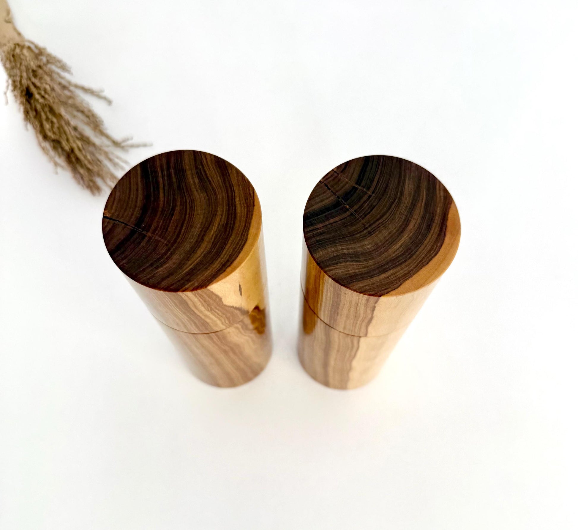 Birdseye view of wooden cylindrical shape salt and pepper grinders made from Australian Buddha timber