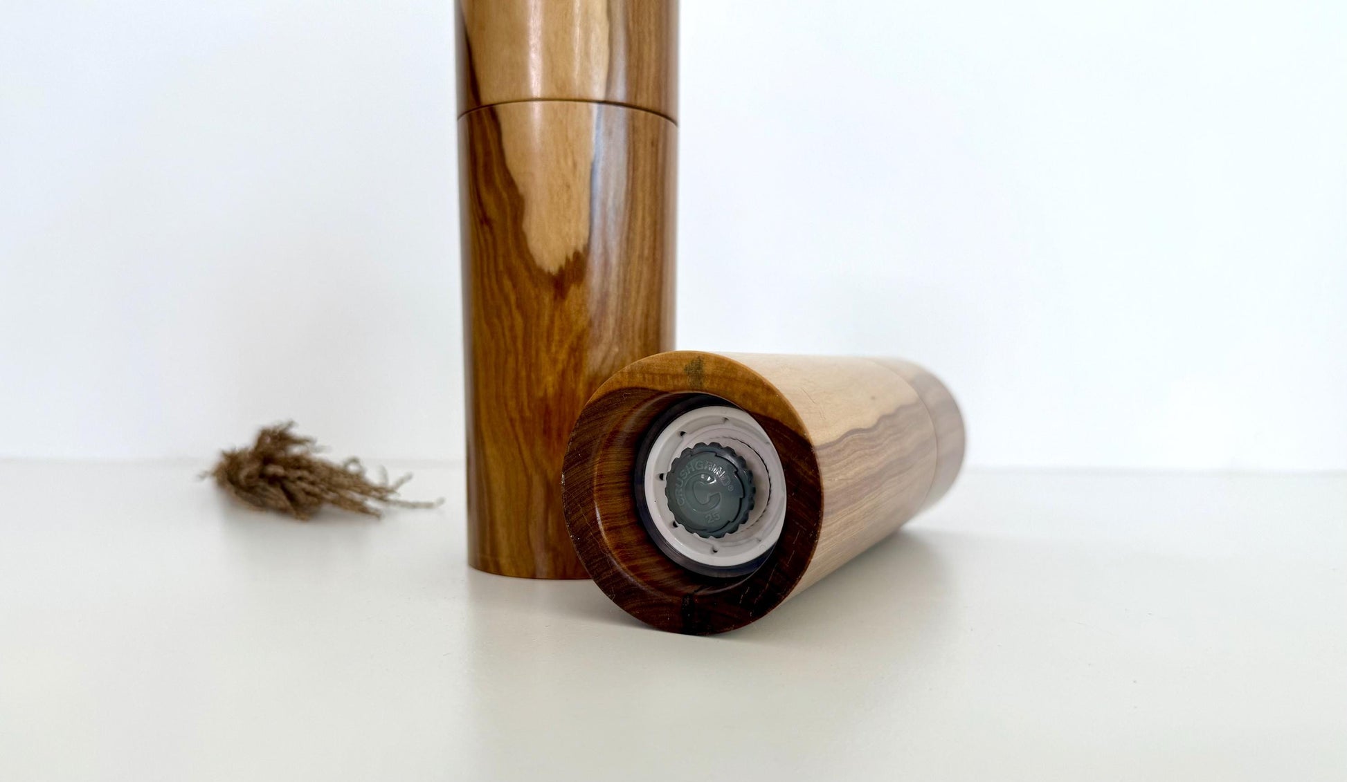 Bottom of salt and pepper grinder showing Crushgrind ceramic grinding mechanism and the adjustment knob