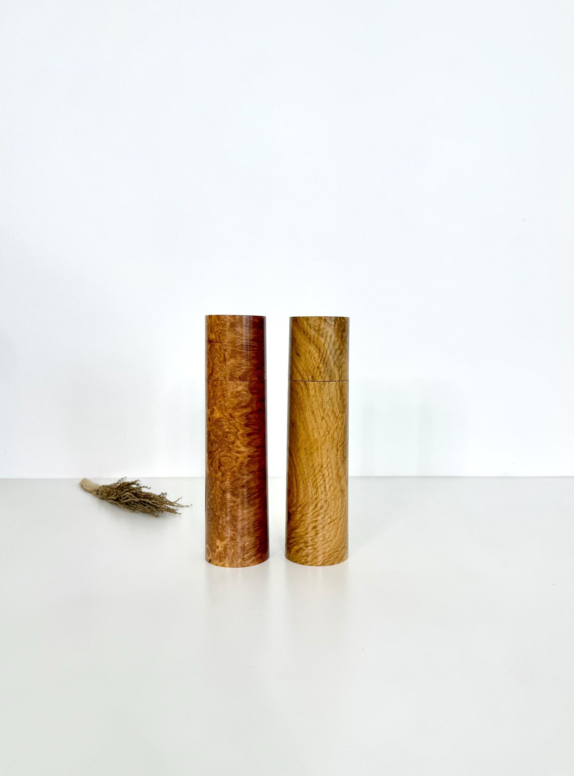 Wooden cylindrical shape salt and pepper grinders made from Red Mallee burl and Bimble Box burl timbers