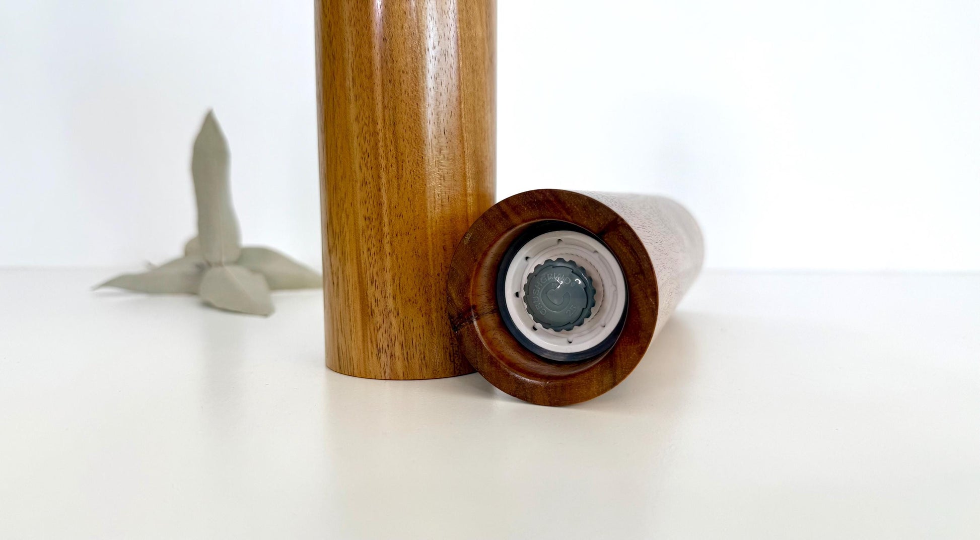 Bottom of salt and pepper grinder showing Crushgrind ceramic grinding mechanism and the adjustment knob