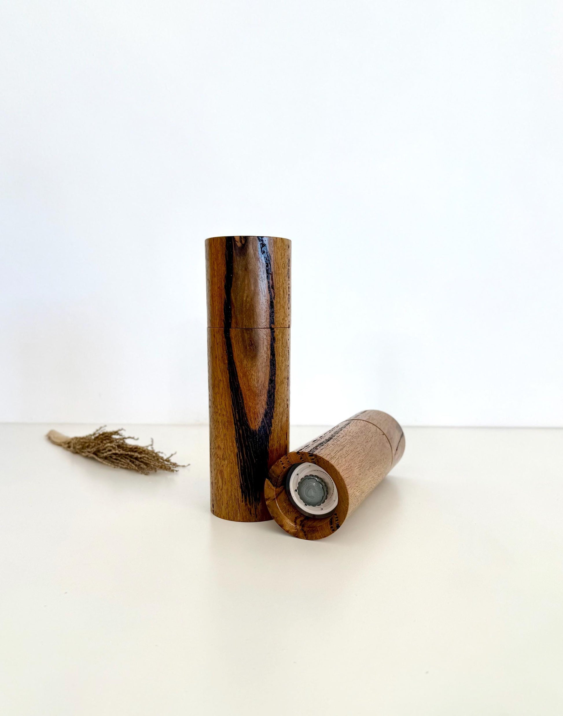 Bottom of salt and pepper grinder showing Crushgrind ceramic grinding mechanism and the adjustment knob