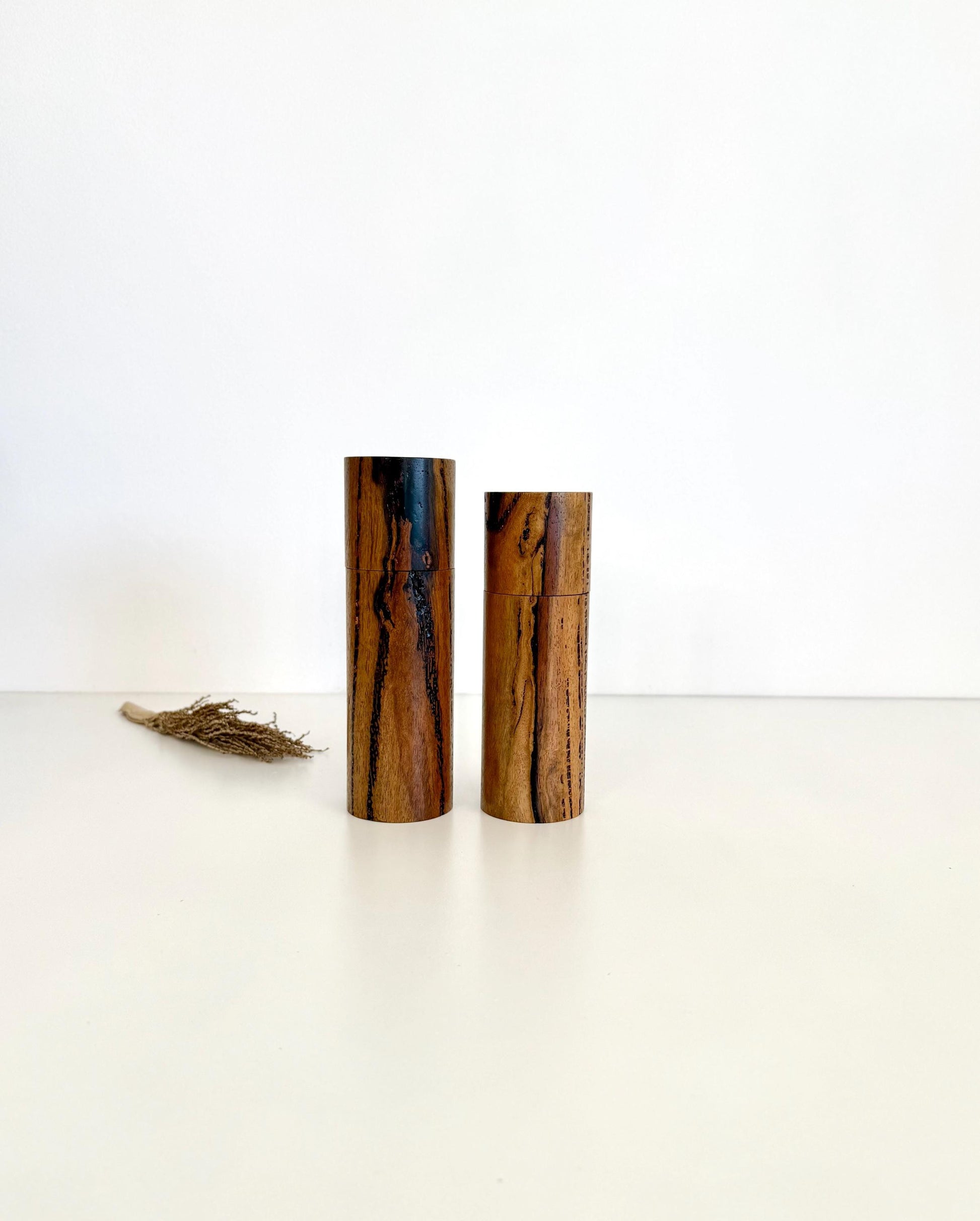 Wooden cylindrical shape salt and pepper grinders made from Marri timber