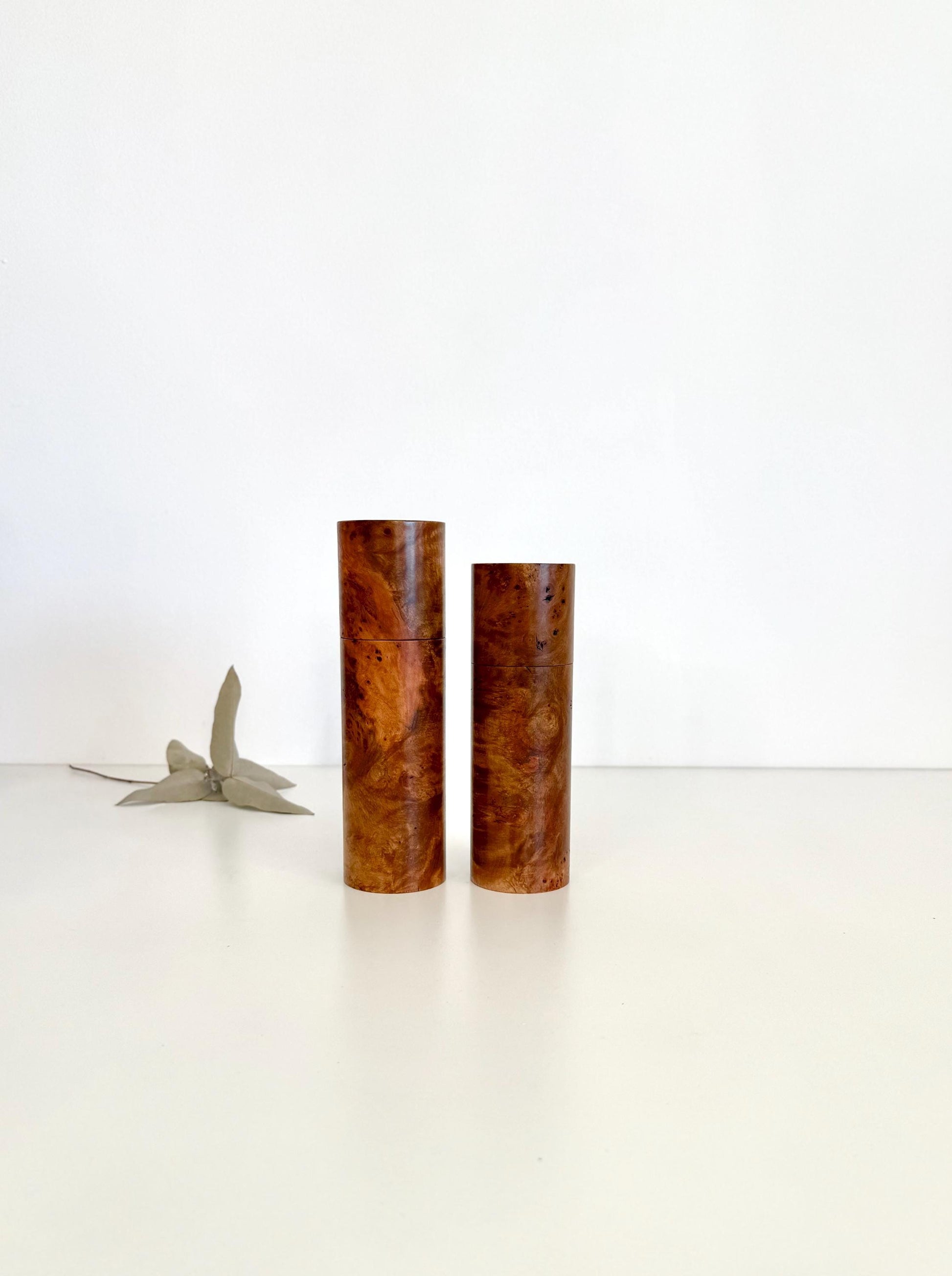 Wooden cylindrical shape salt and pepper grinders made from Mrytle burl timber