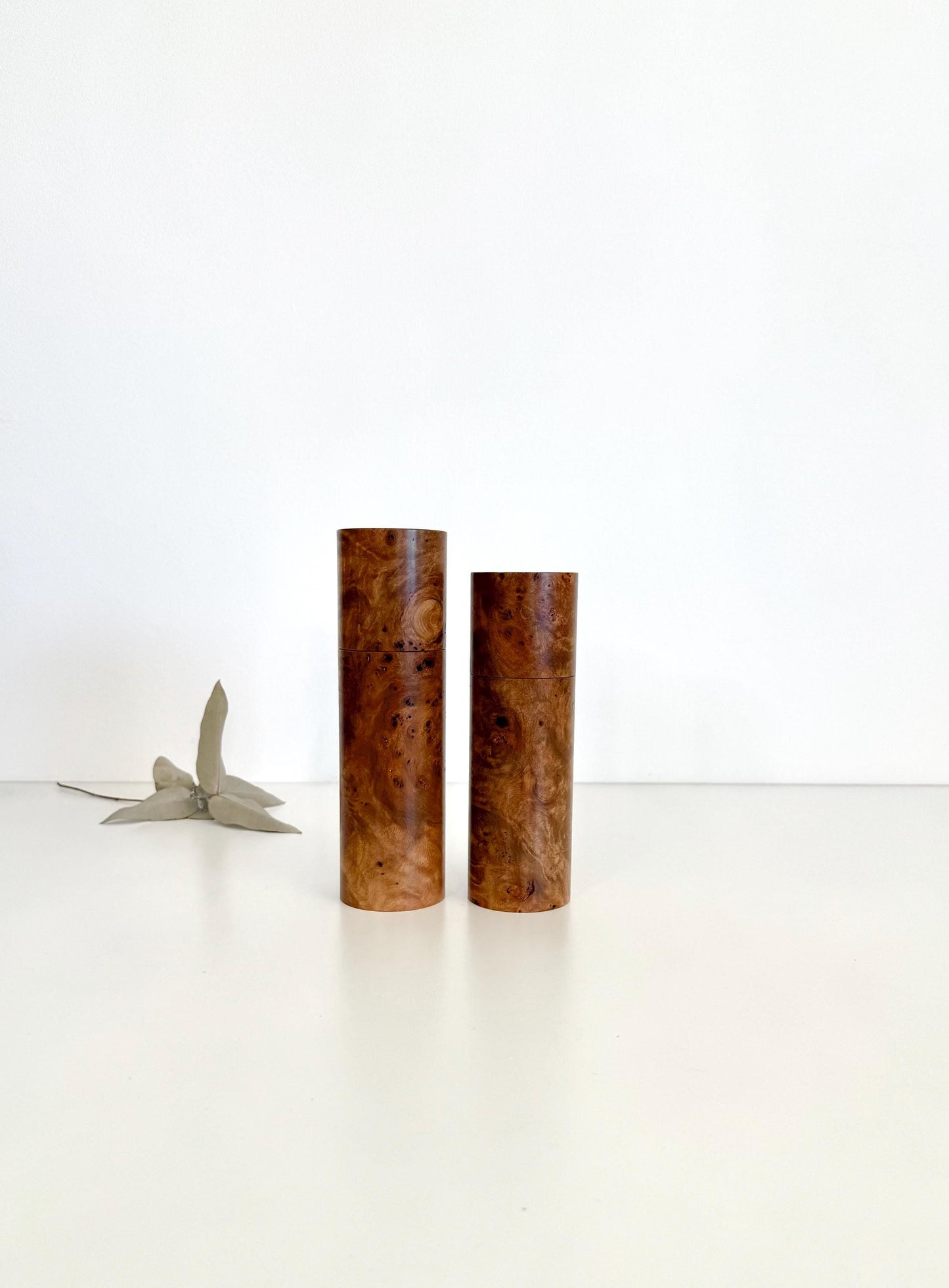 Wooden cylindrical shape salt and pepper grinders made from Mrytle burl timber