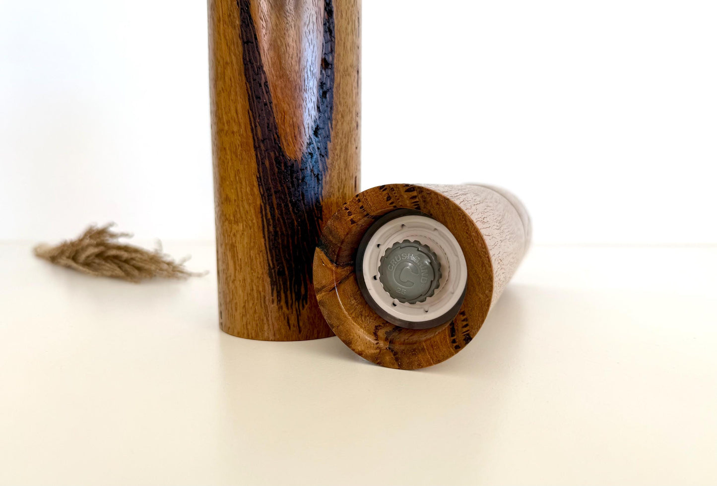 Bottom of salt and pepper grinder showing Crushgrind ceramic grinding mechanism and the adjustment knob
