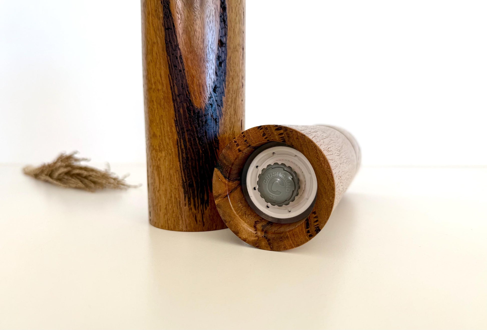 Bottom of salt and pepper grinder showing Crushgrind ceramic grinding mechanism and the adjustment knob