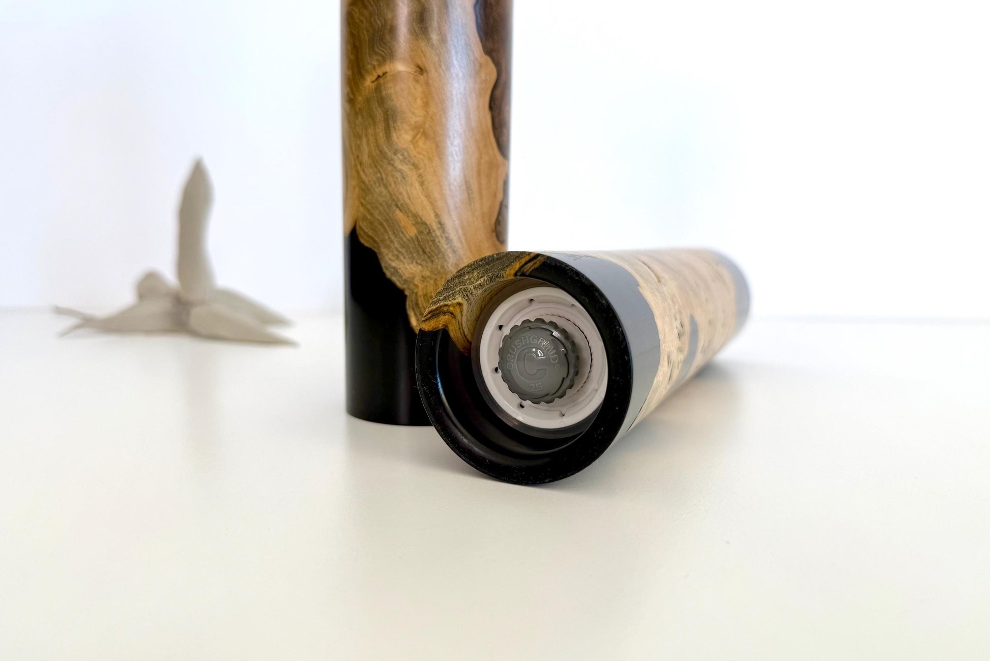 Bottom of salt and pepper grinder showing Crushgrind ceramic grinding mechanism and the adjustment knob