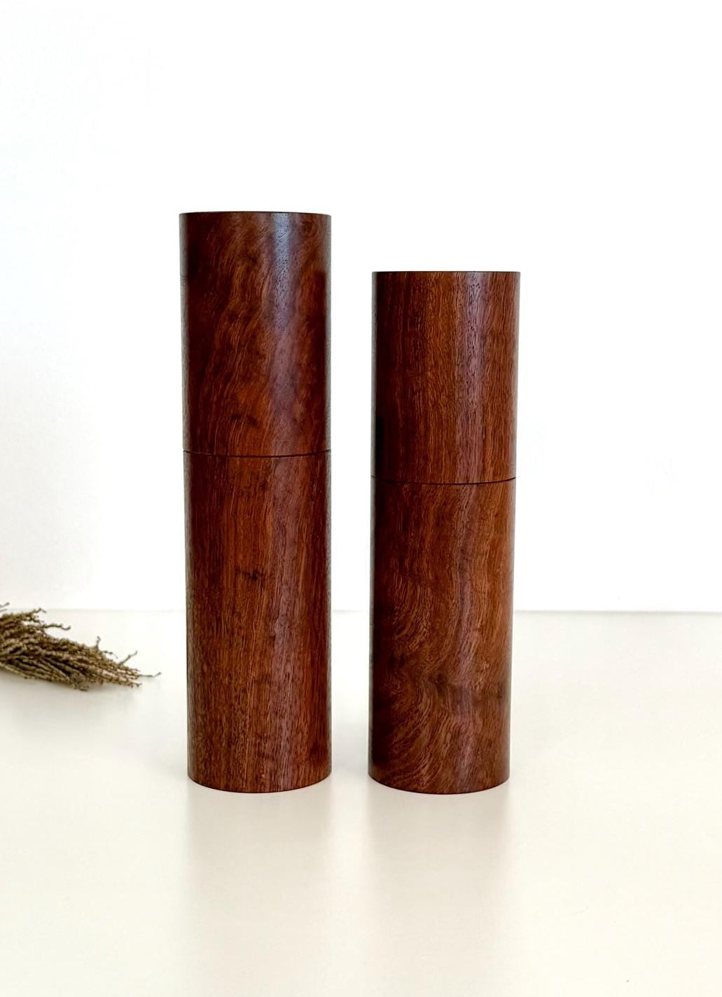 Wooden cylindrical shape salt and pepper grinders made from Black Fleck Jarrah Timber