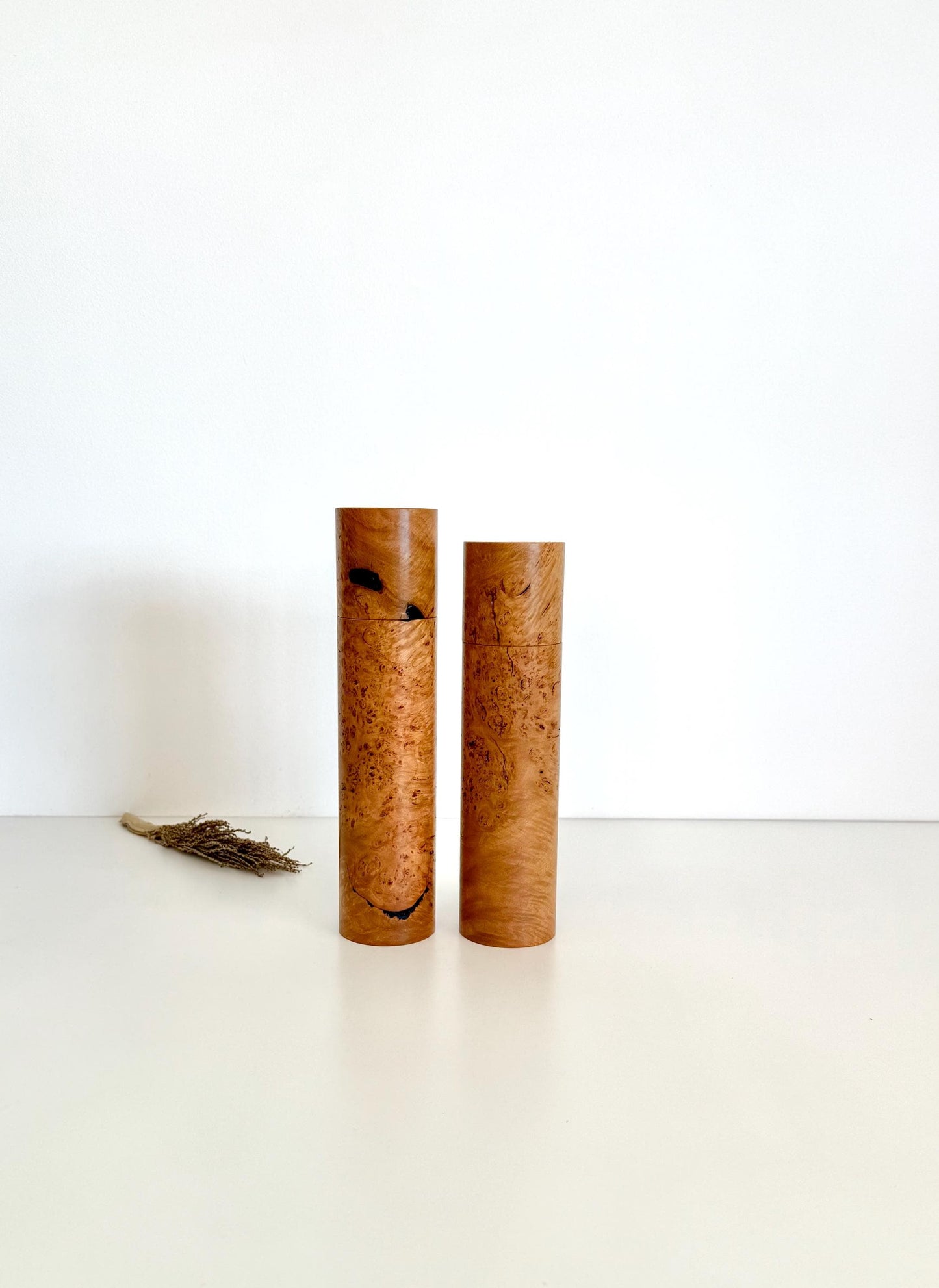 Wooden cylindrical shape salt and pepper grinders made from brown burl timber