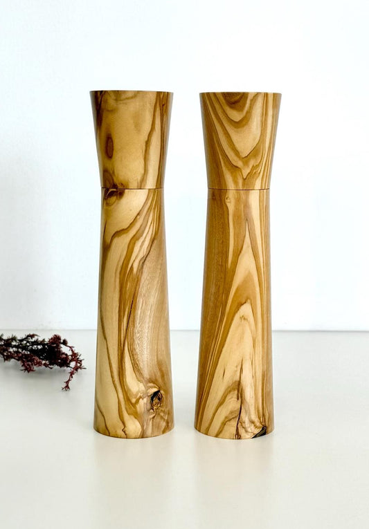 Wooden cylindrical shape salt and pepper grinders made from light brown patterned timber