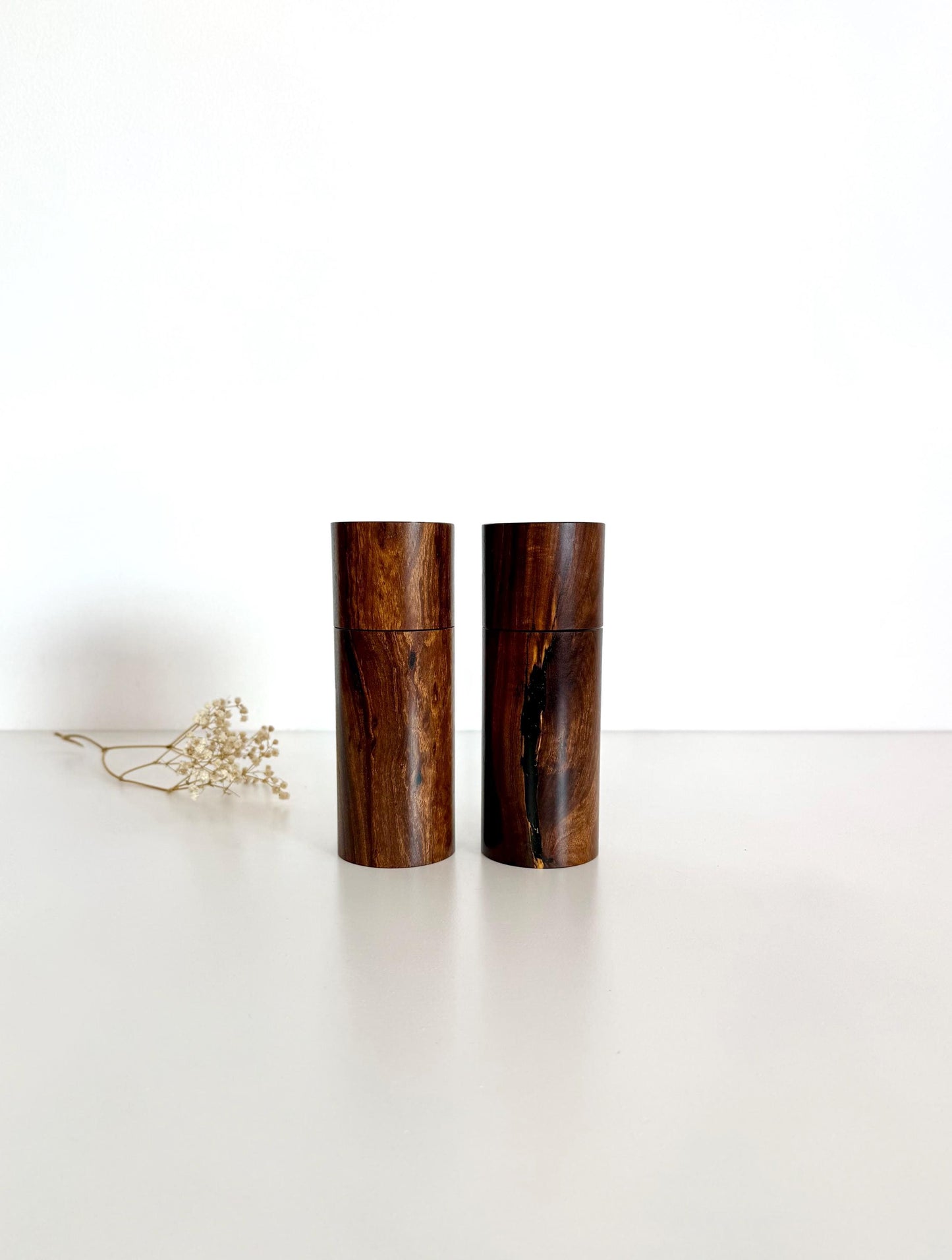 Wooden cylindrical shape salt and pepper grinders made from dark brown timber