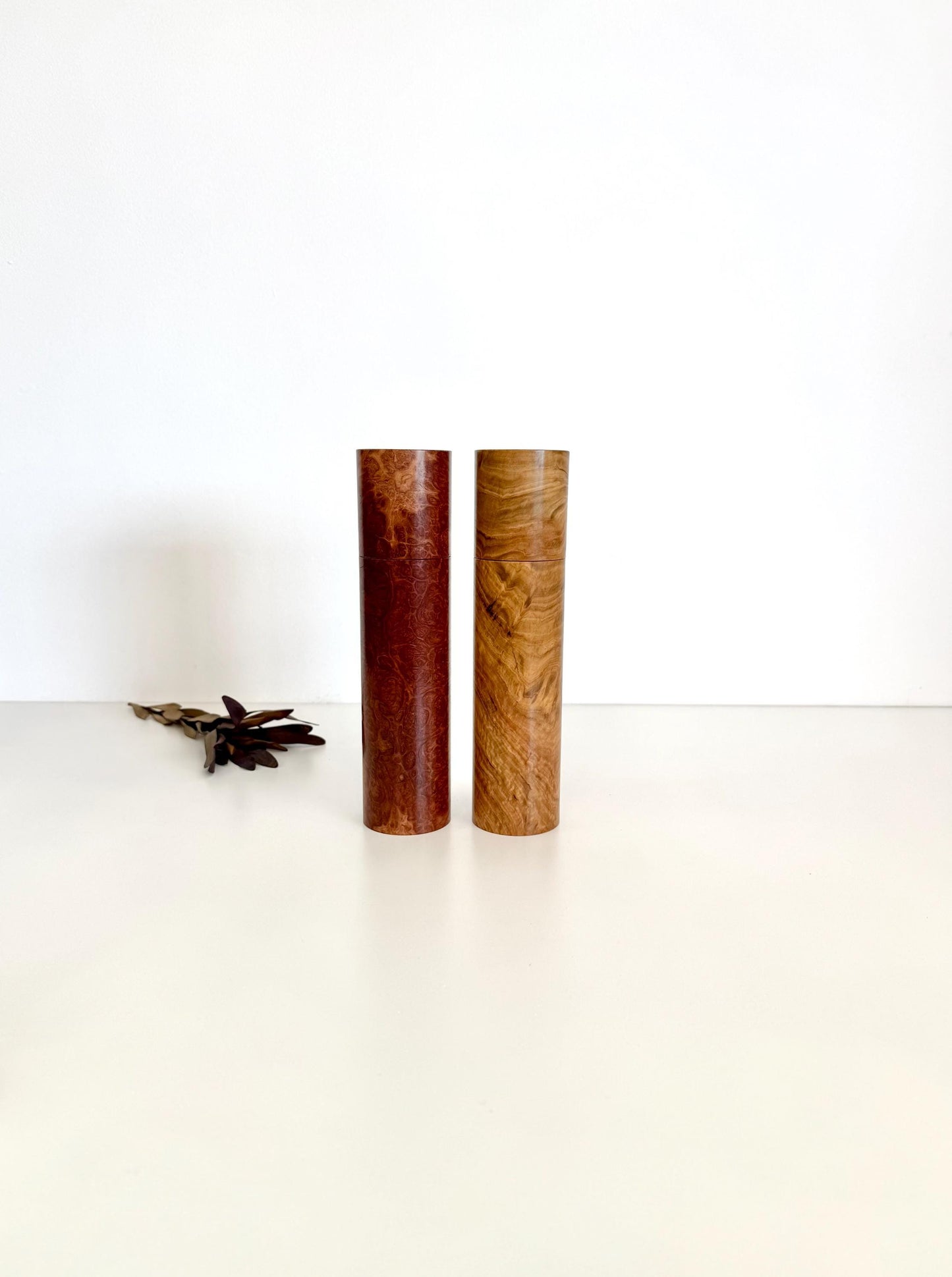 Wooden cylindrical shape salt and pepper grinders made from brown burl timber